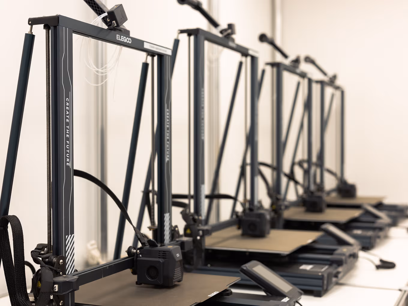Row of FDM filament 3D printers in Exhibit Studio's custom fabrication facility
