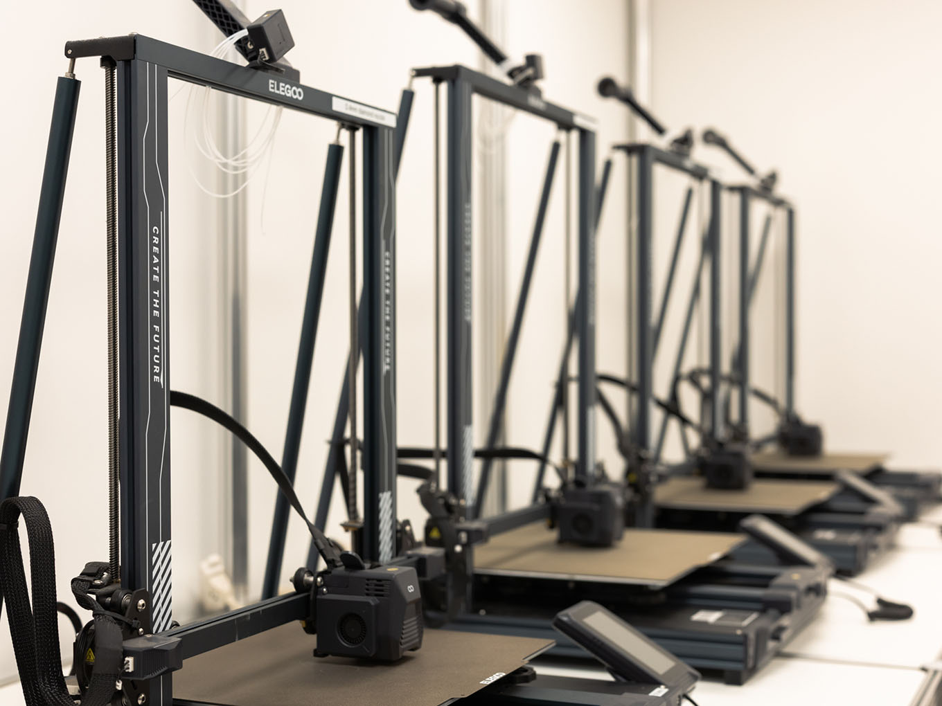 Row of FDM filament 3D printers in Exhibit Studio's custom fabrication facility