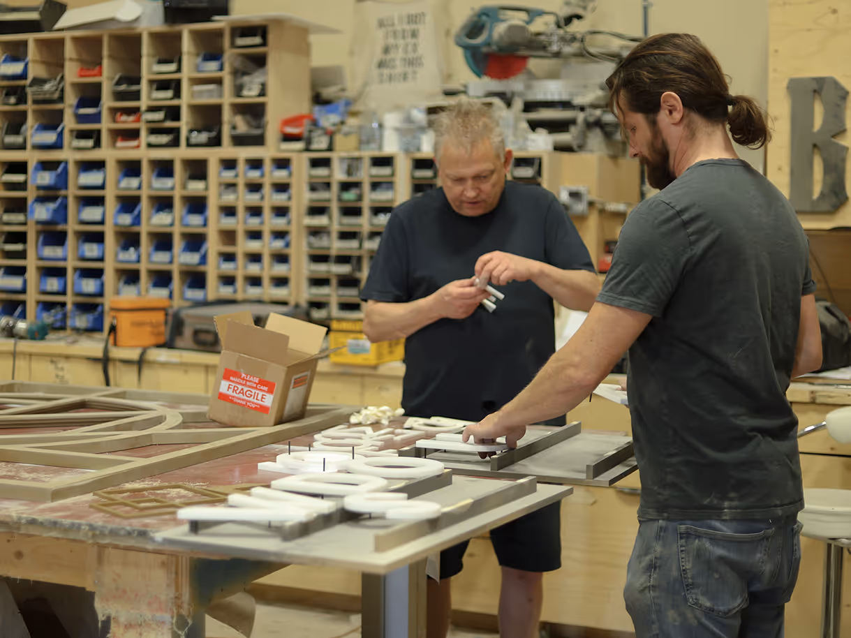 Fabrication team assembling custom dimensional lettering for Fuze Iced Tea Flavour Lounge experiential airport installation
