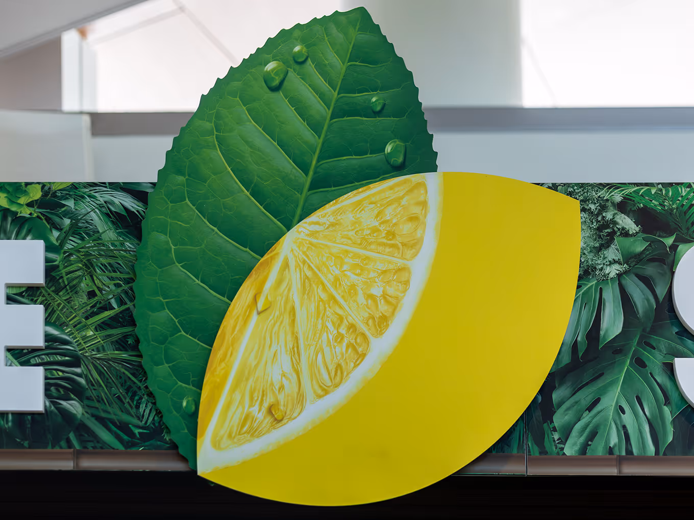 Large-scale custom lemon and leaf dimensional graphic centrepiece for Fuze Iced Tea Flavour Lounge airport brand activation
