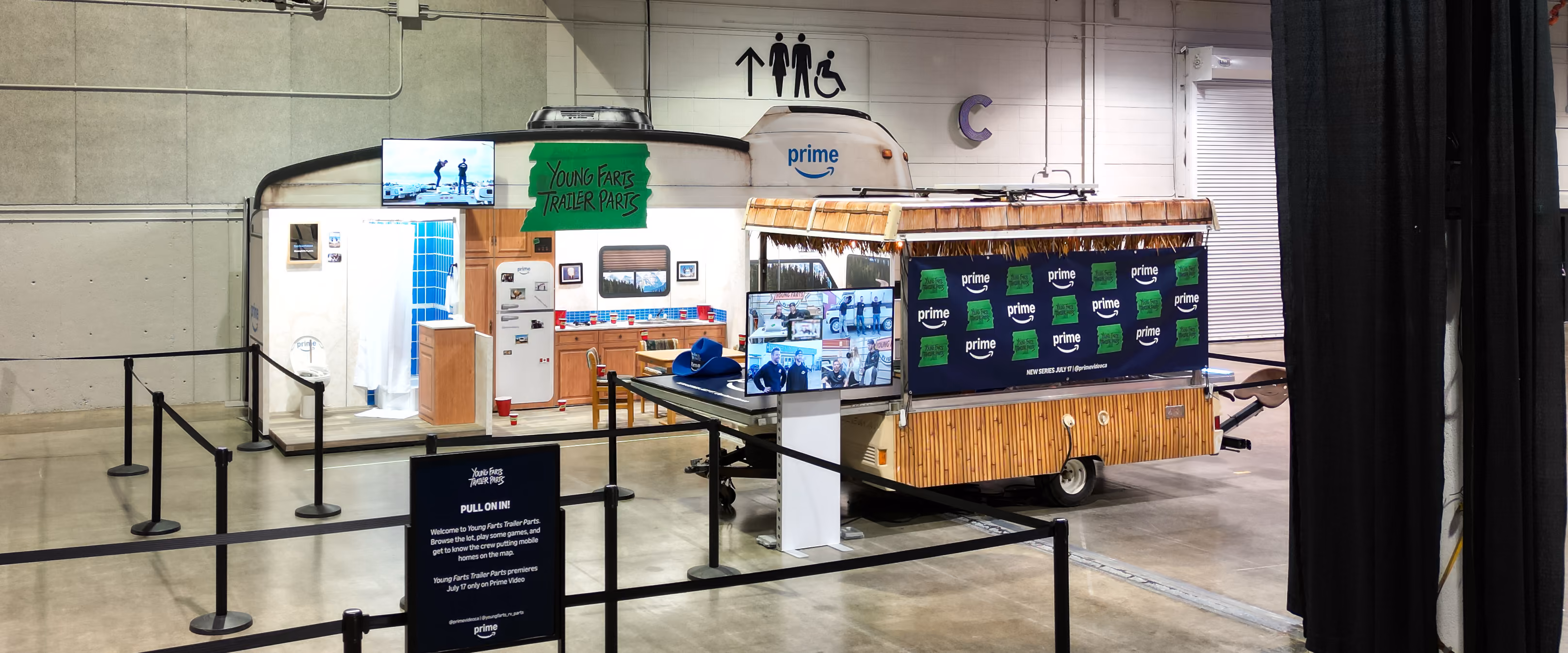 Custom RV façade activation for Young Farts Trailer Parts with kitchen, bathroom, and party trailer at Calgary Stampede.