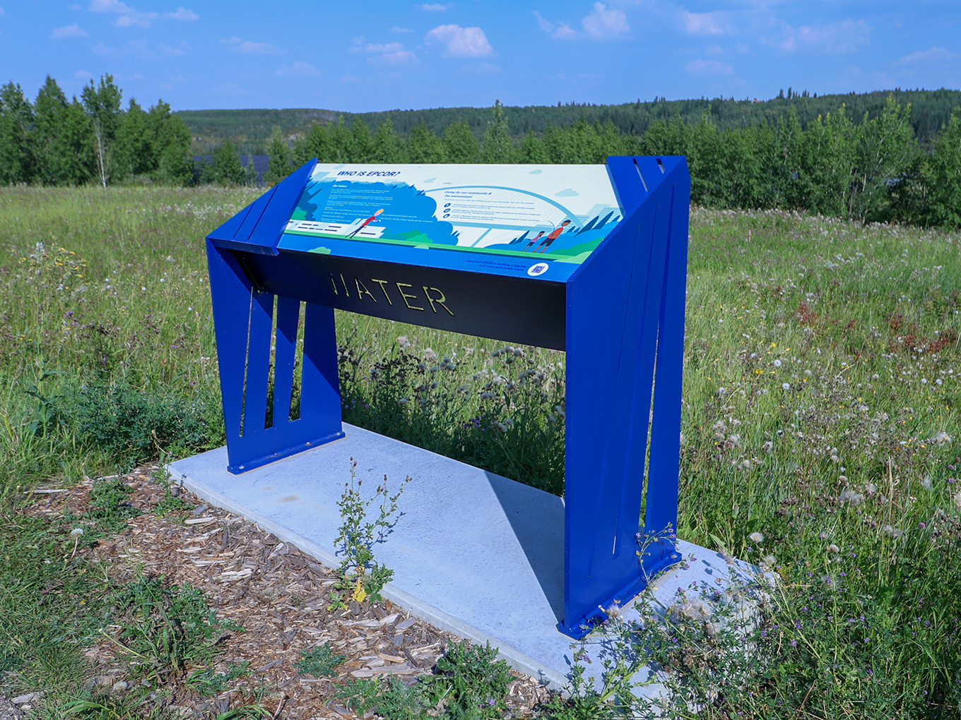 "Water" interpretive sign in an open field, topped with a "Who is EPCOR?" graphic panel.