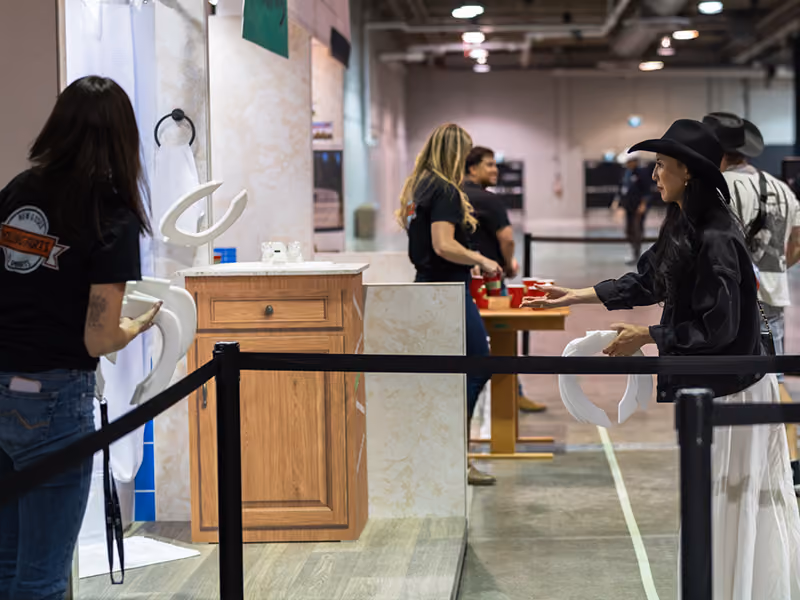 A visitor tosses a toilet seat during the ring toss game at the Young Farts Trailer Parts activation.