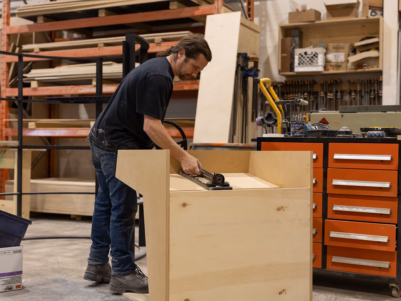 An Exhibit Studio fabricator builds custom millwork cabinetry for the Young Farts Trailer Parts RV activation.