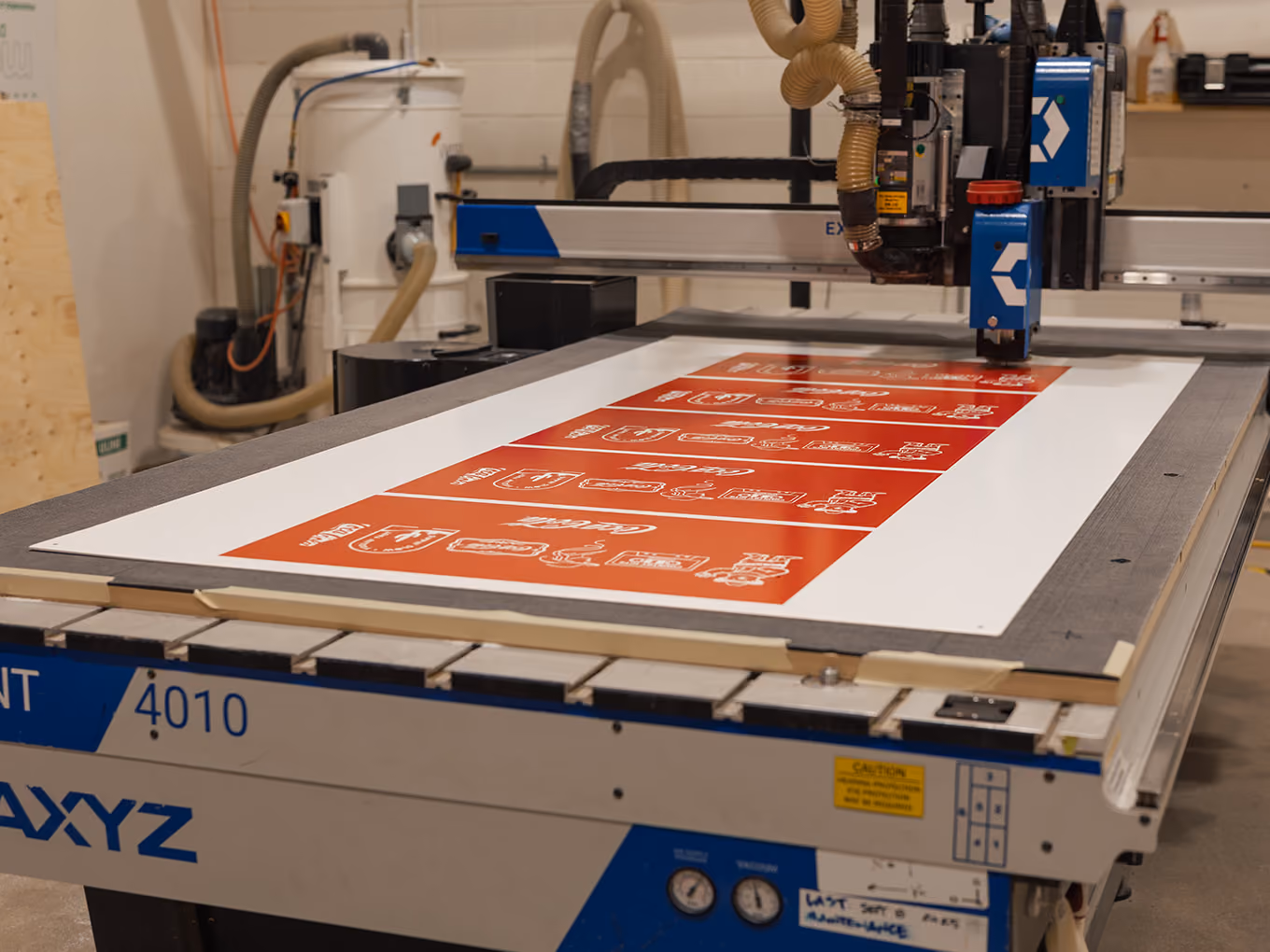 CNC router cutting custom Coca-Cola graphic panels during production of the Ink Studio seacan.