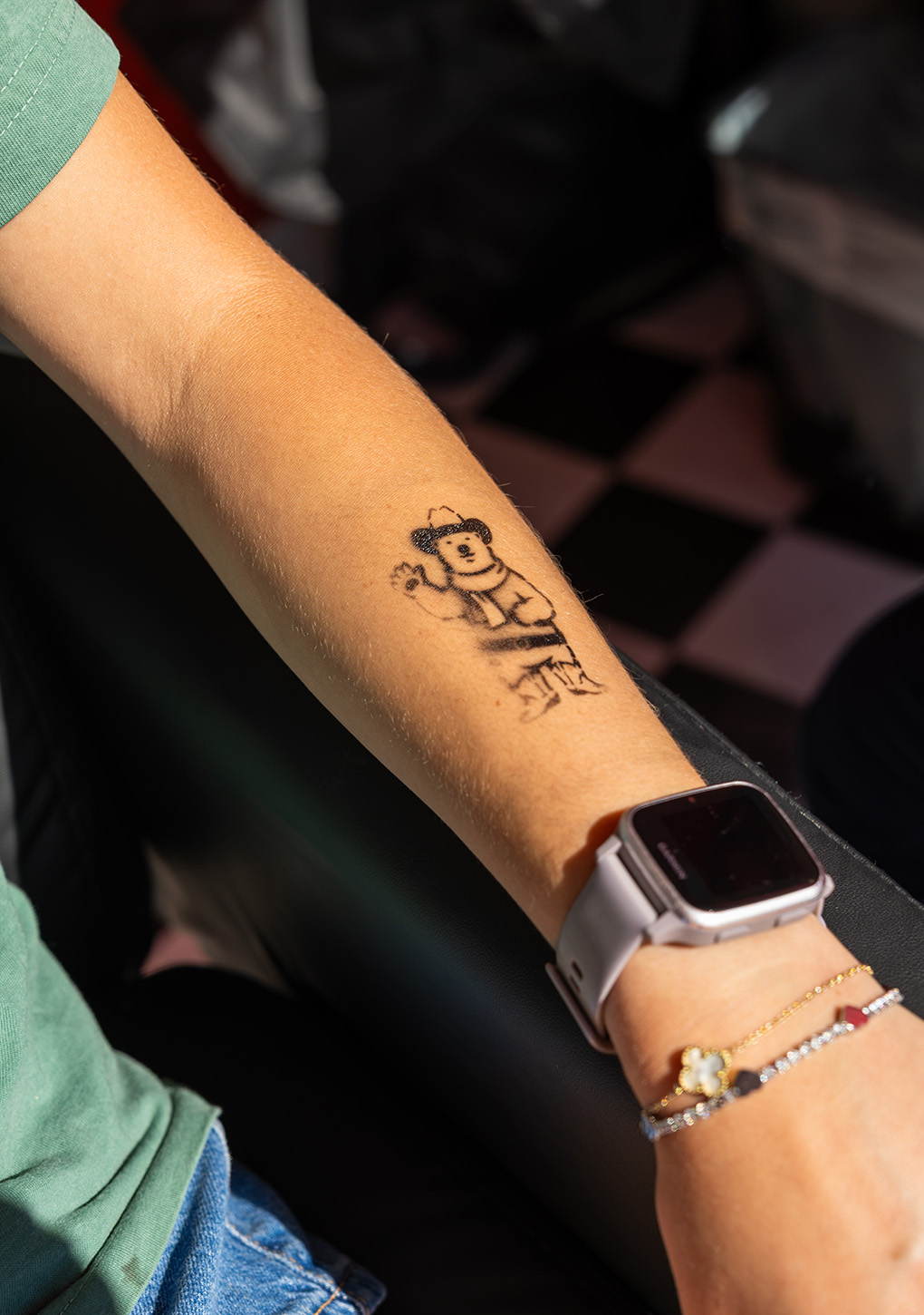 Close-up of a free temporary tattoo design applied to a visitor's arm at the Coca-Cola Ink Studio activation.