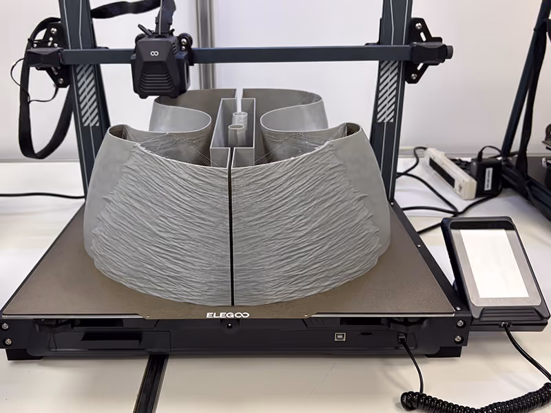 3D printer forming a large-scale curved vehicle display component for the GMC Parade Vehicle project.