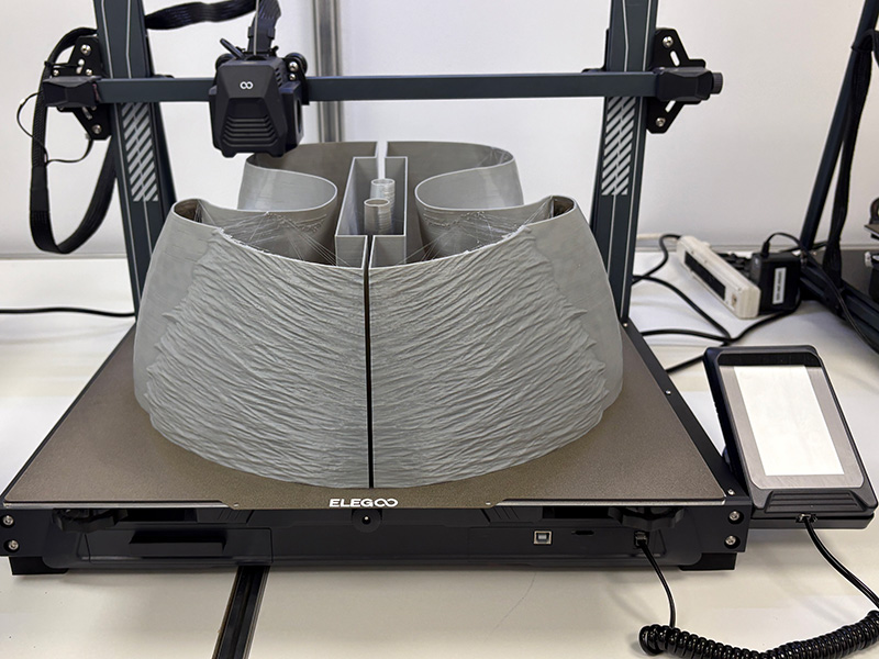 3D printer forming a large-scale curved vehicle display component for the GMC Parade Vehicle project.