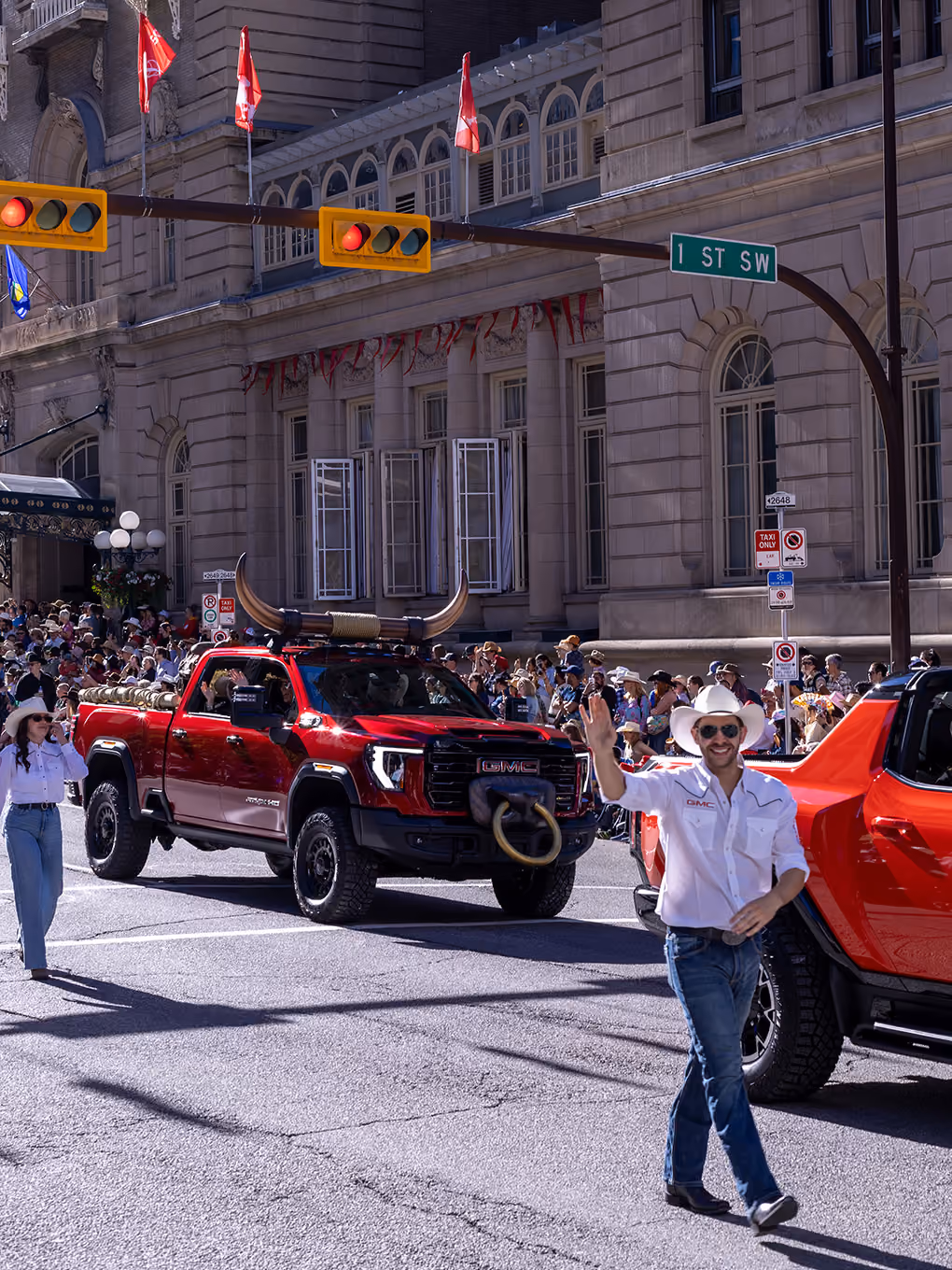 Custom GMC parade truck with fabricated bull horns and nose ring driving down a Calgary Stampede parade route.