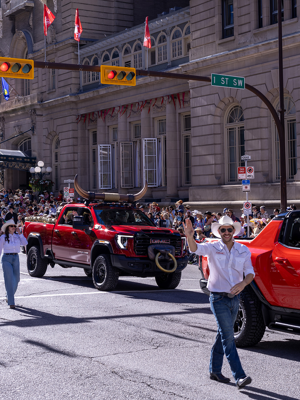Custom GMC parade truck with fabricated bull horns and nose ring driving down a Calgary Stampede parade route.