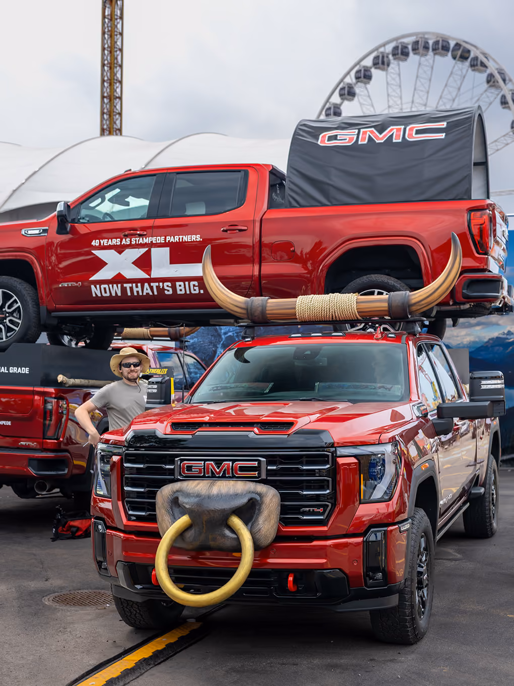 Exhibit Studio team member with the custom GMC bull horn truck display at the Calgary Stampede grounds.