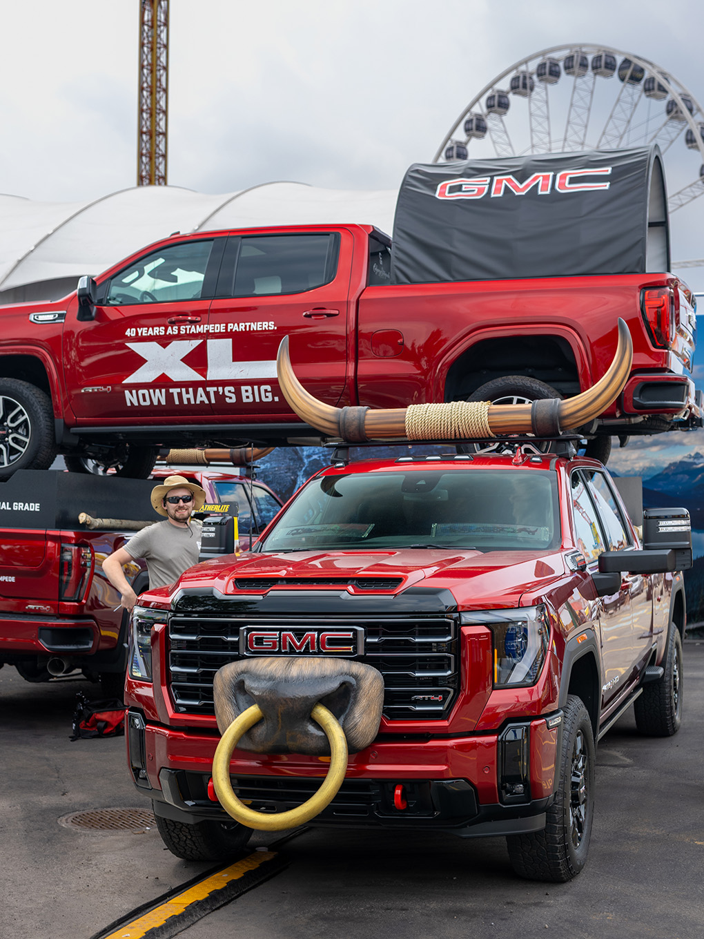 Exhibit Studio team member with the custom GMC bull horn truck display at the Calgary Stampede grounds.