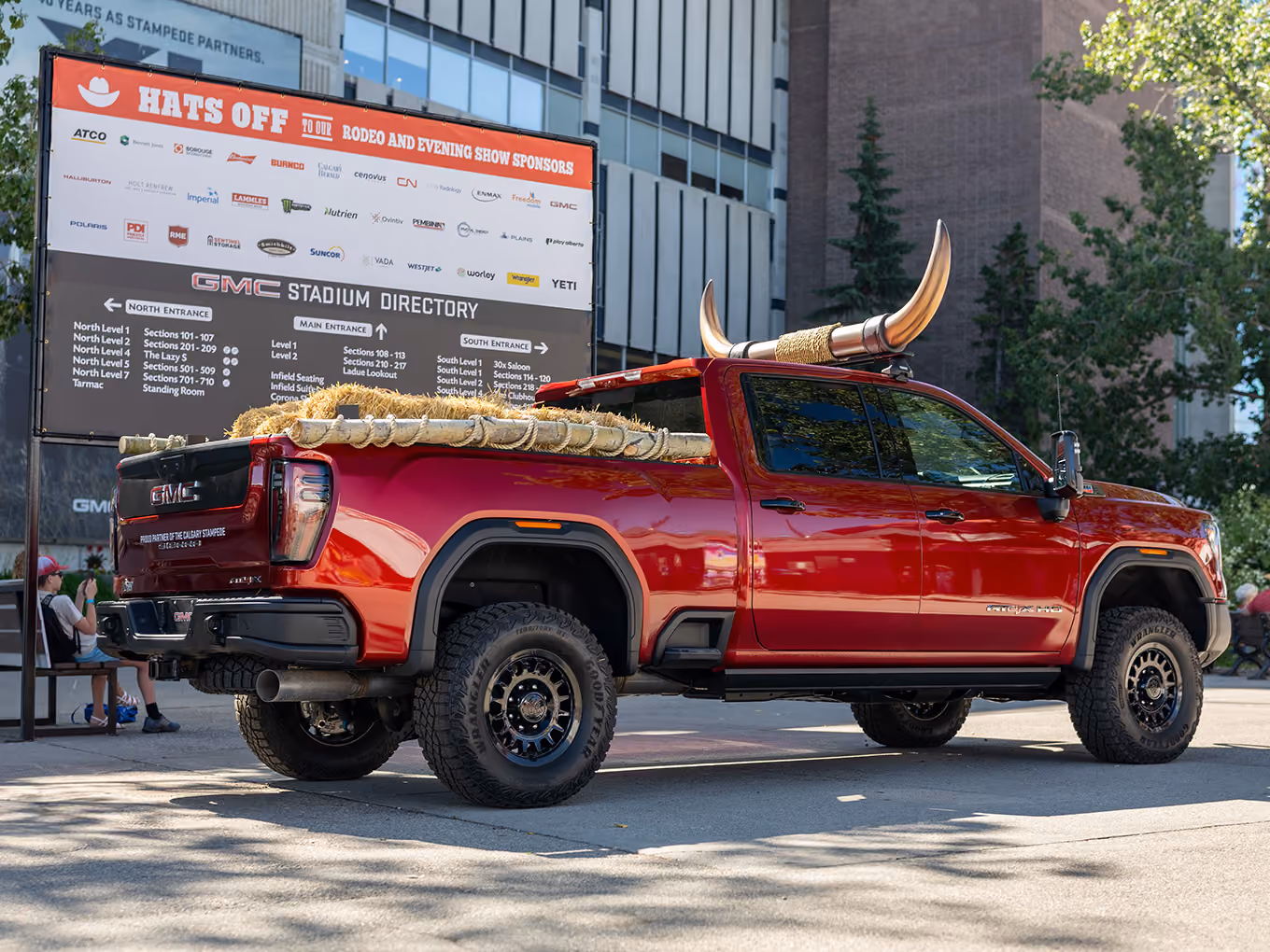 Side view of the custom GMC parade truck with fabricated horn topper and hay bale bed styling.
