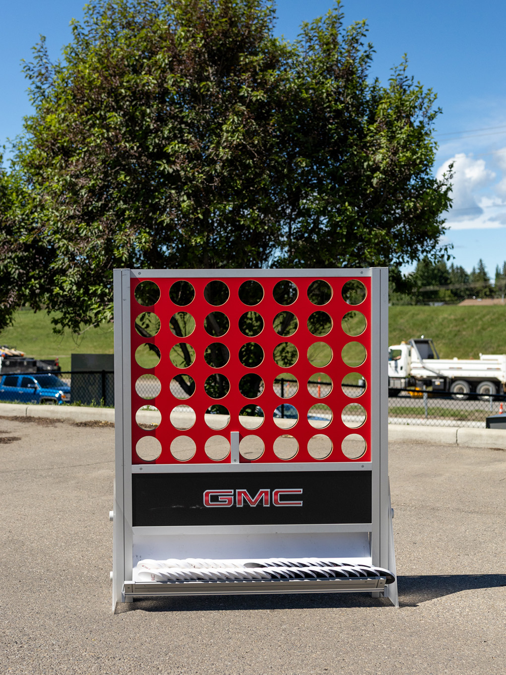 Oversized GMC-branded Connect 4 game staged outdoors for a Calgary Stampede activation.