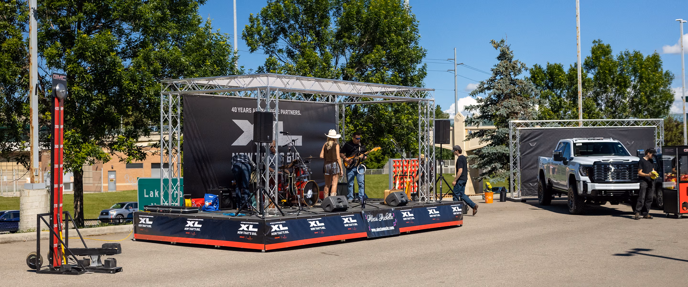 music stage and carnival-style branded games for a GMC outdoor event during Calgary Stampede