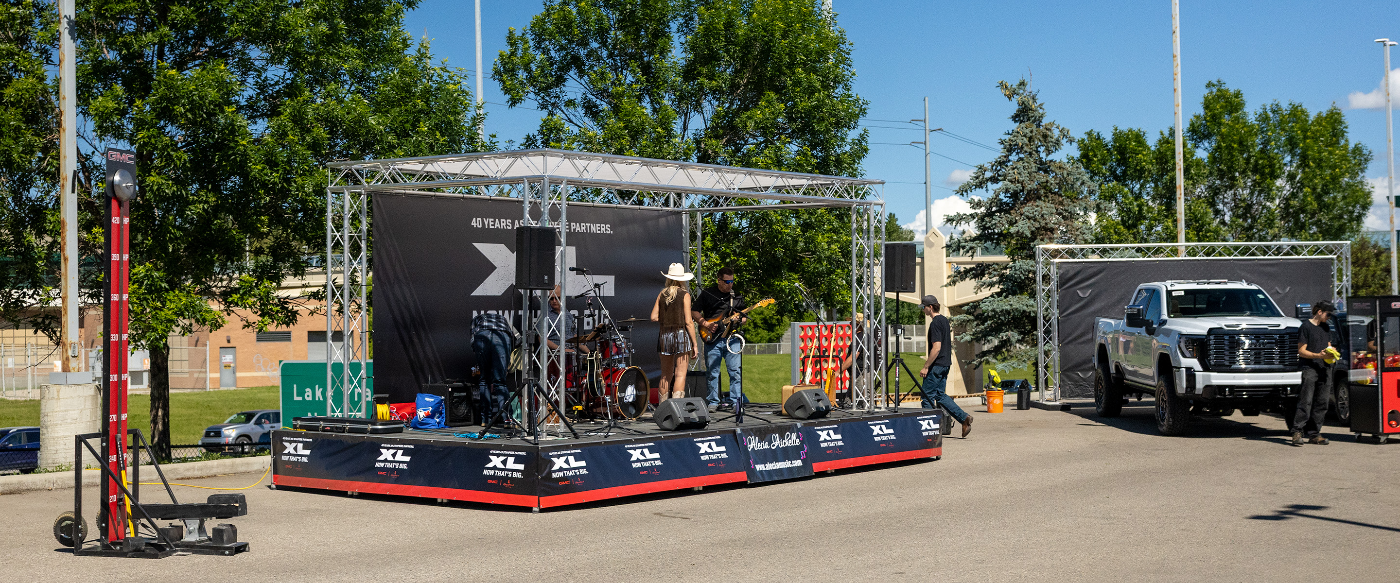 music stage and carnival-style branded games for a GMC outdoor event during Calgary Stampede