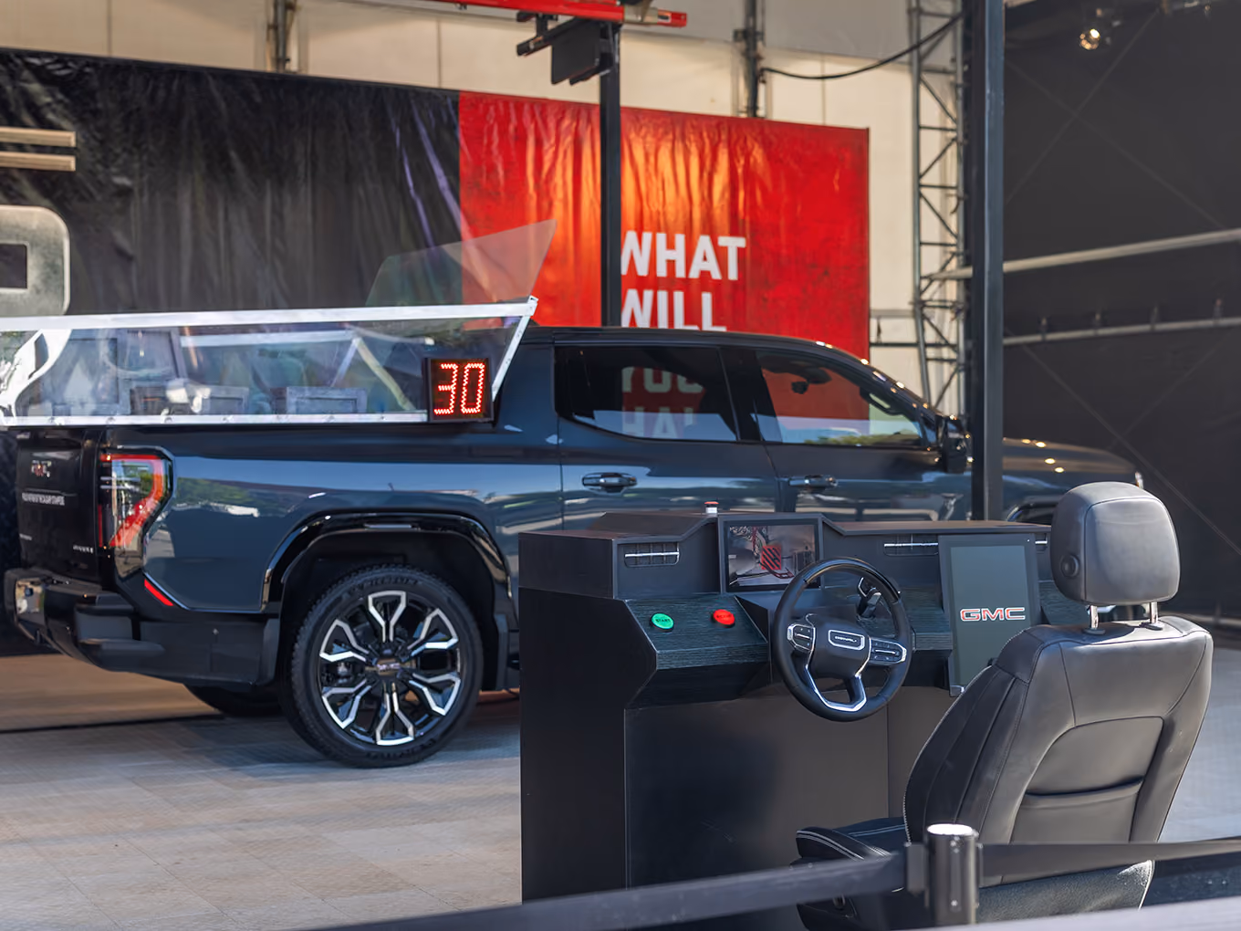 Custom claw crane and control station positioned beside the GMC truck bed prize game.