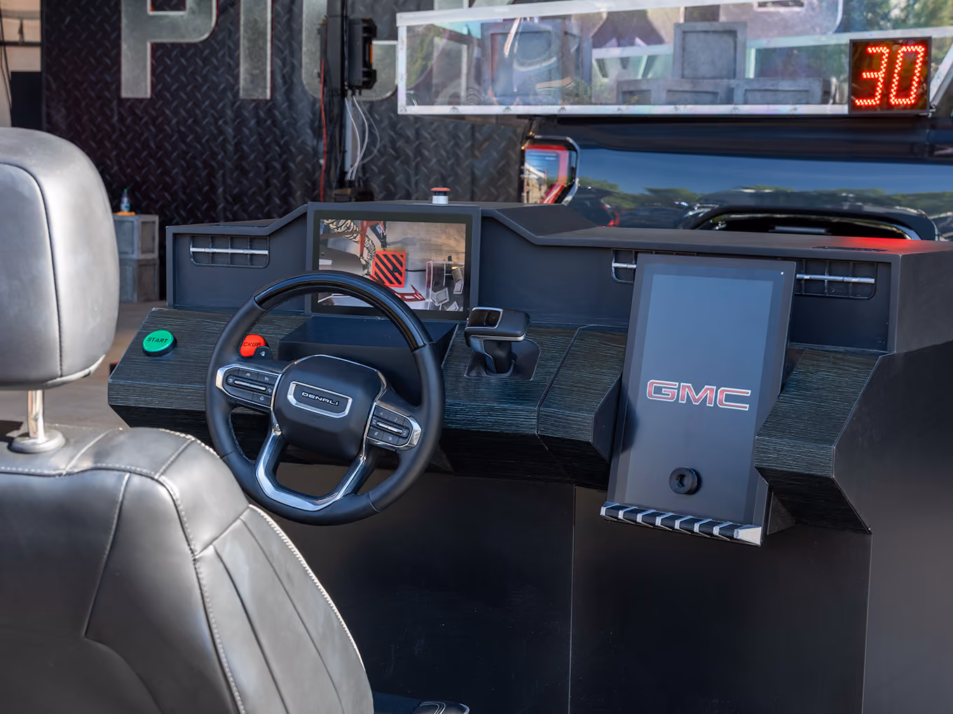 close up the giant claw machine game control station that uses a steering wheel to control the claw mechanism