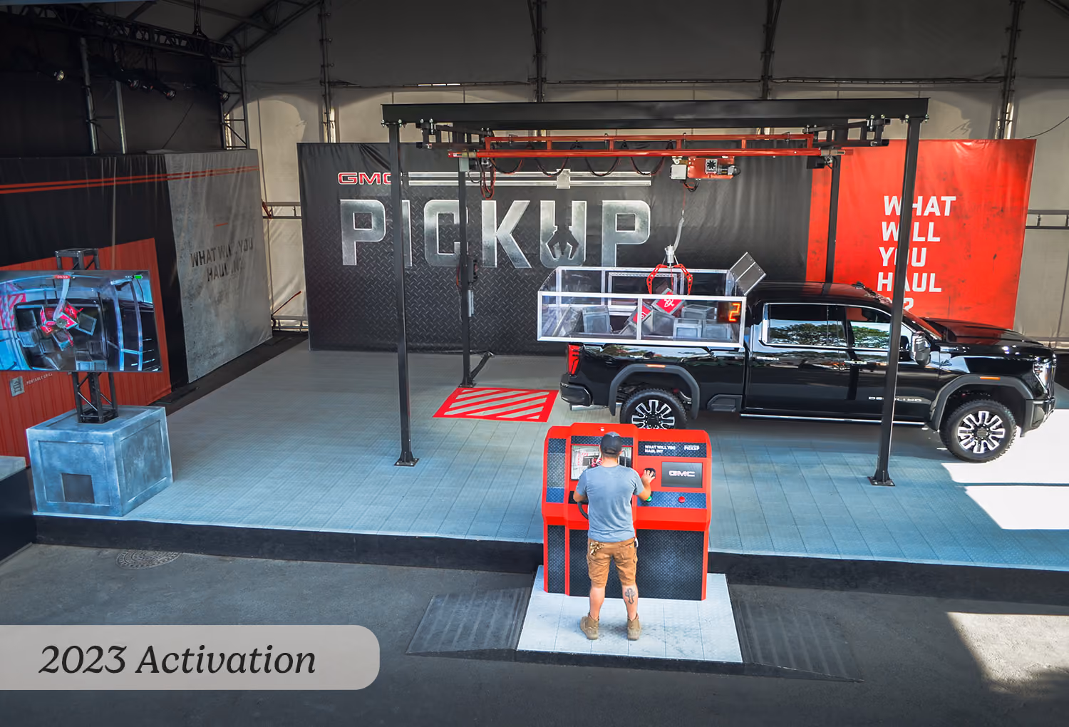 2023 aerial view of the GMC claw machine activation, control station, and live-view monitor display.