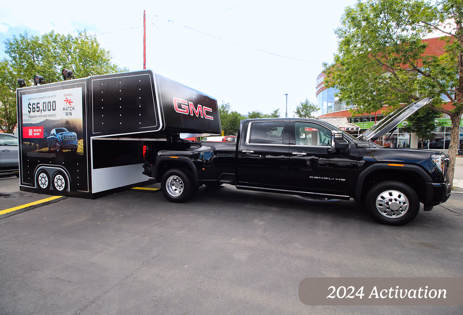 2024 GMC contest trailer towed by a Sierra HD Denali parked at a Calgary Stampede satellite location.
