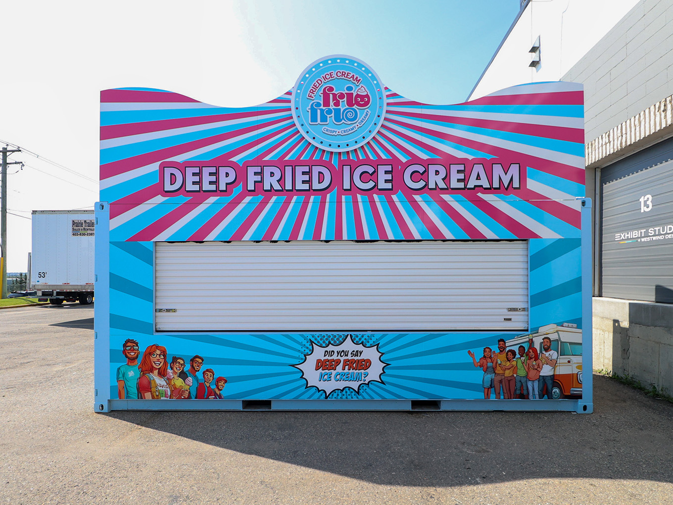Front view of the finished Frio Frio stand, with a custom sunburst header, illustrated characters and a "Did you say deep fried ice cream?" graphic.