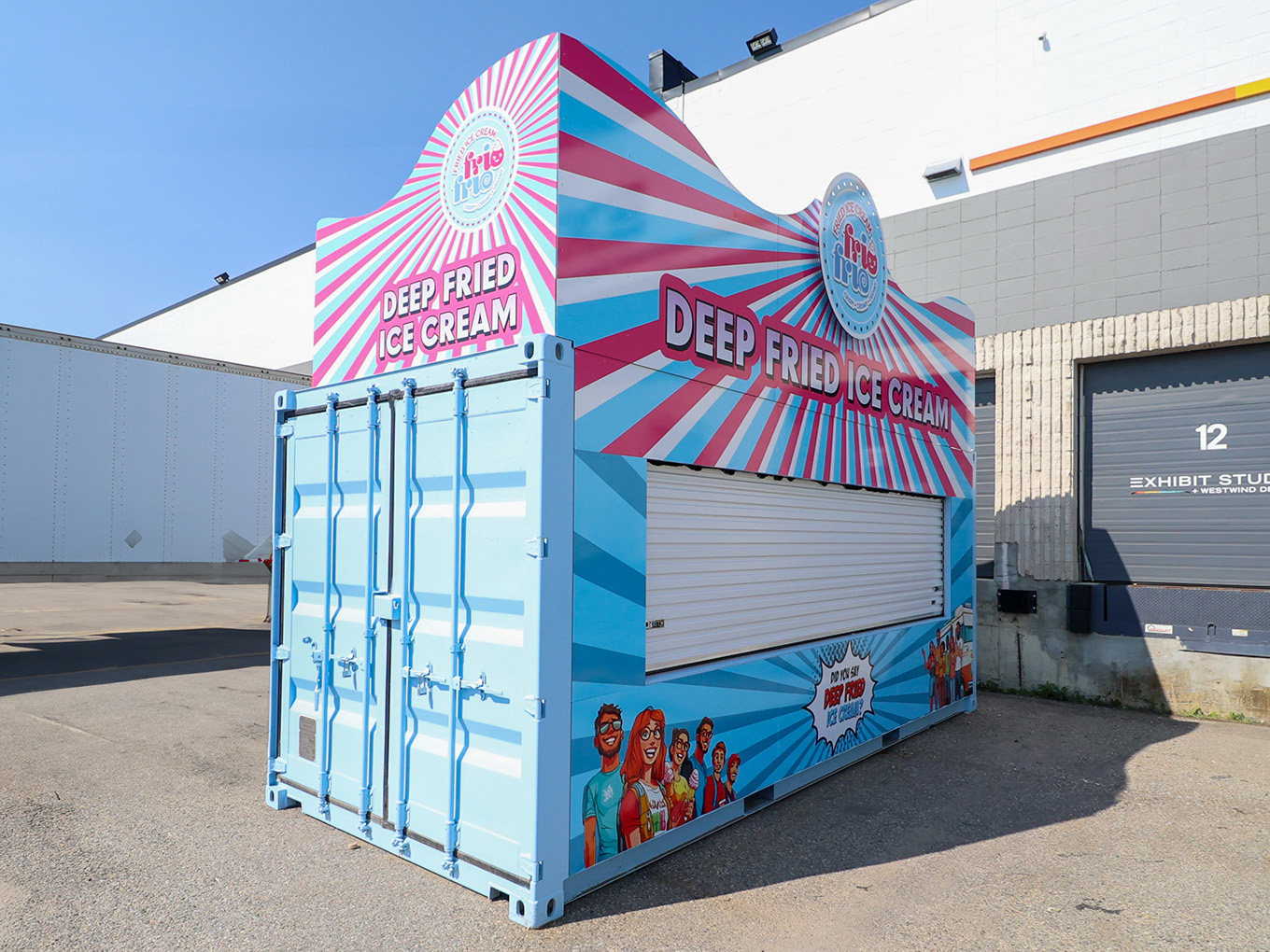 The finished Frio Frio container stand with its service shutter closed, parked outside the Exhibit Studio loading bay.