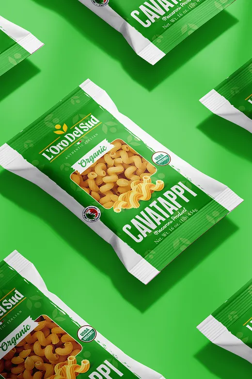 Packets of L'Oro Del Sud Organic Cavatappi pasta arranged on a green background.