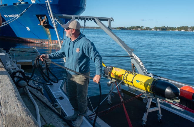Kevin Rand ties up the SMELTS Ocean Researcher boat at the Woods Hole Oceanographic Docks arriving with the Redwing autonomous underwater glider for the kick off ceremony for the round the world Sentinel Mission . Photo taken on Oct. 10, 2025