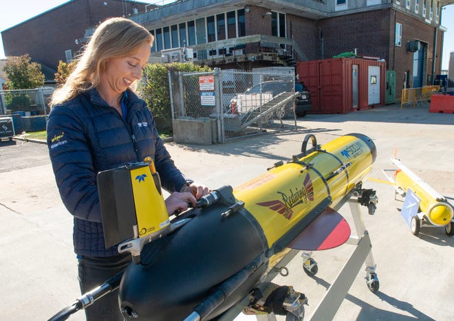 Teledyne glider support manager Cordie Goodrich activates the underwater glider Redwing at the Woods Hole Oceanographic Docks for the kick off ceremony of the Sentinel Mission. The Mission will send the glider on an around the world trip stopping at 7 different ports. The voyage will take 1,553 days, total travel distance 63,463 kilometers. Photo taken on Oct. 10, 2025