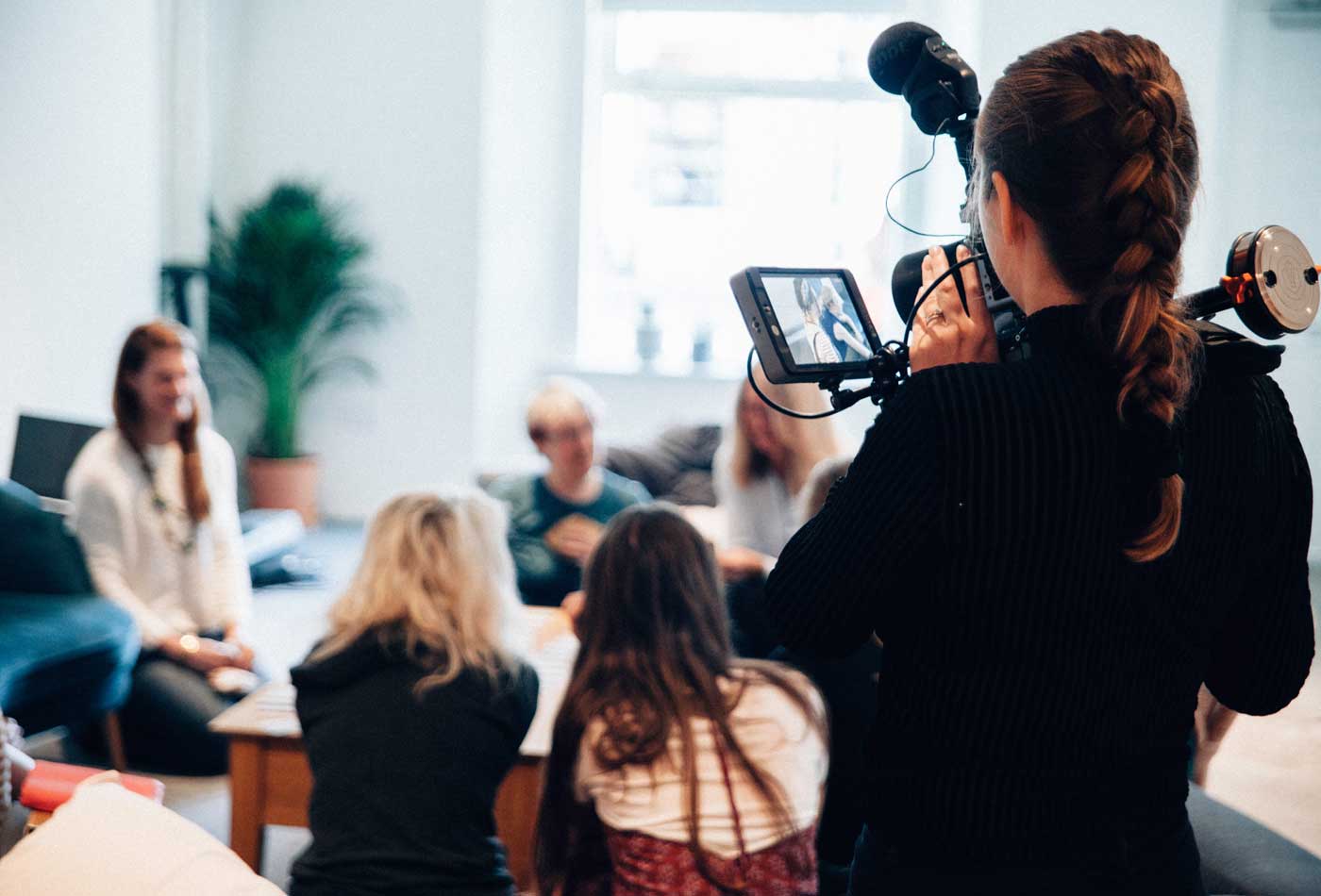 Shows a person recording a group of people - Public relations research
