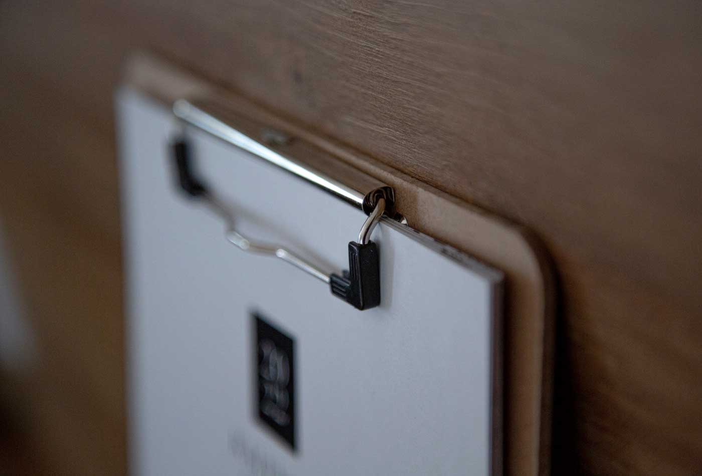 Shows a clipboard on a desk