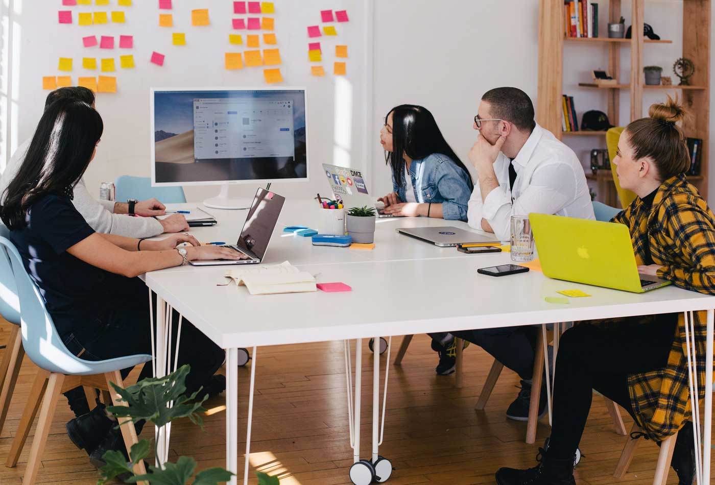 Shows a group of people at a strategy meeting