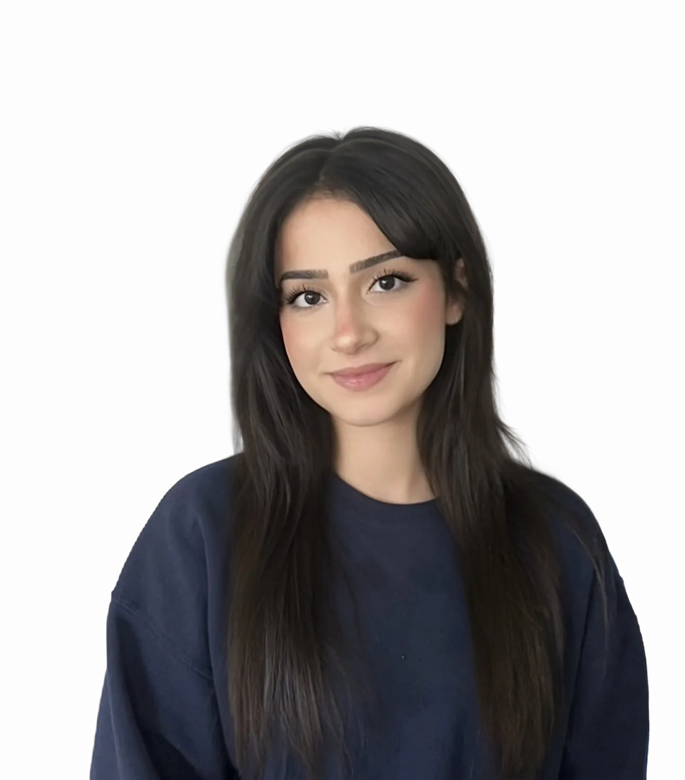 Smiling young woman with long dark hair wearing a denim jacket and light gray shirt against a plain beige background.
