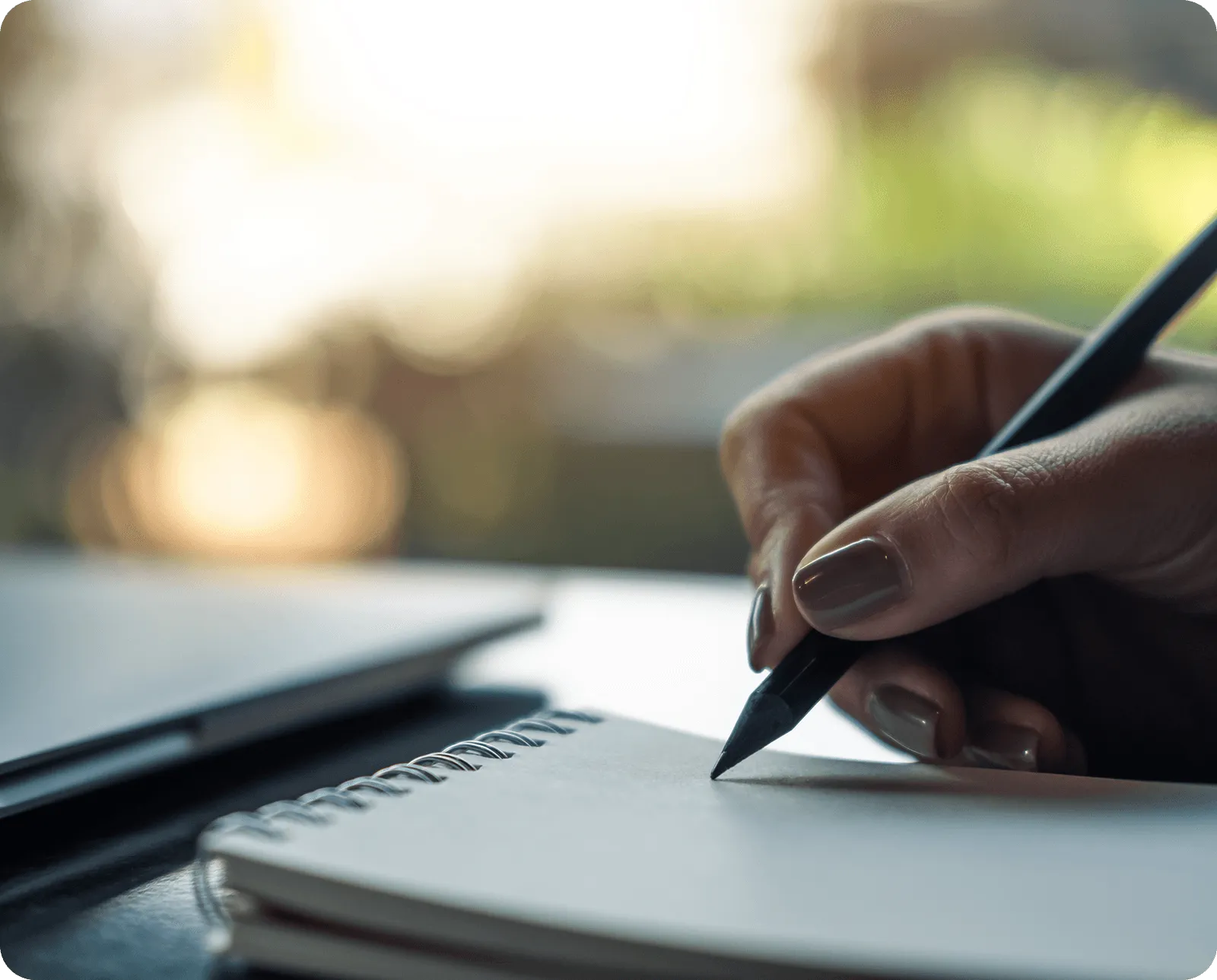 A pen writing on a notebook