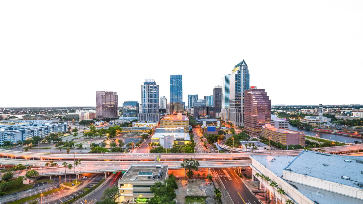 Modern city skyline surrounded by lush greenery, representing sustainable commercial construction and property management excellence in Florida.