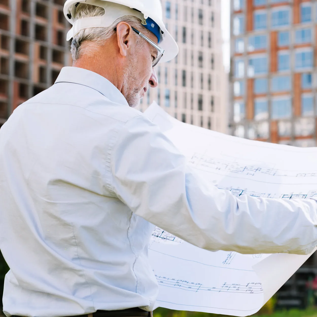 Maintenance supervisor reviewing building plans representing GQM Inc.’s responsive maintenance support in Florida.