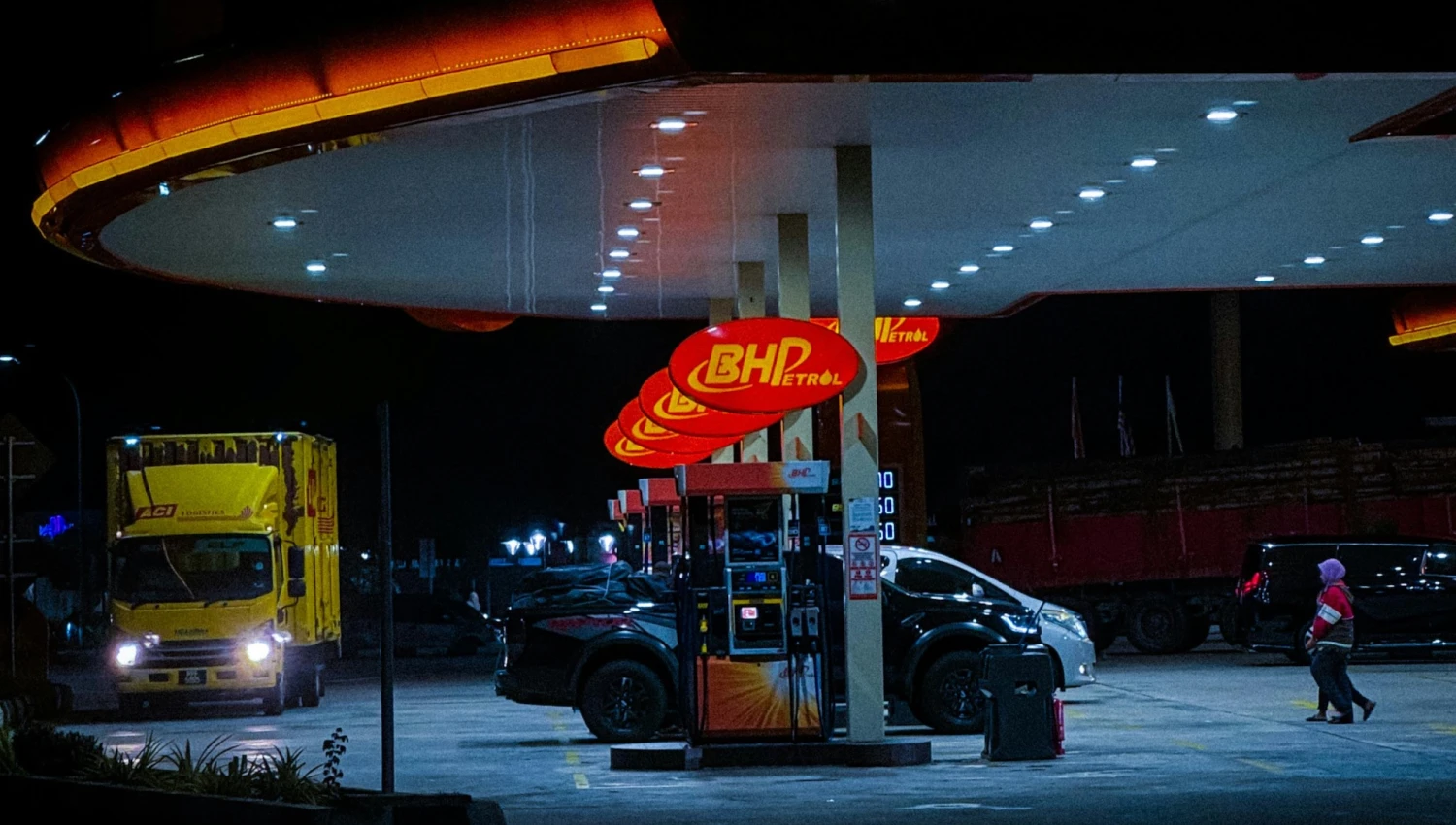 Trucks filling up on fuel at night