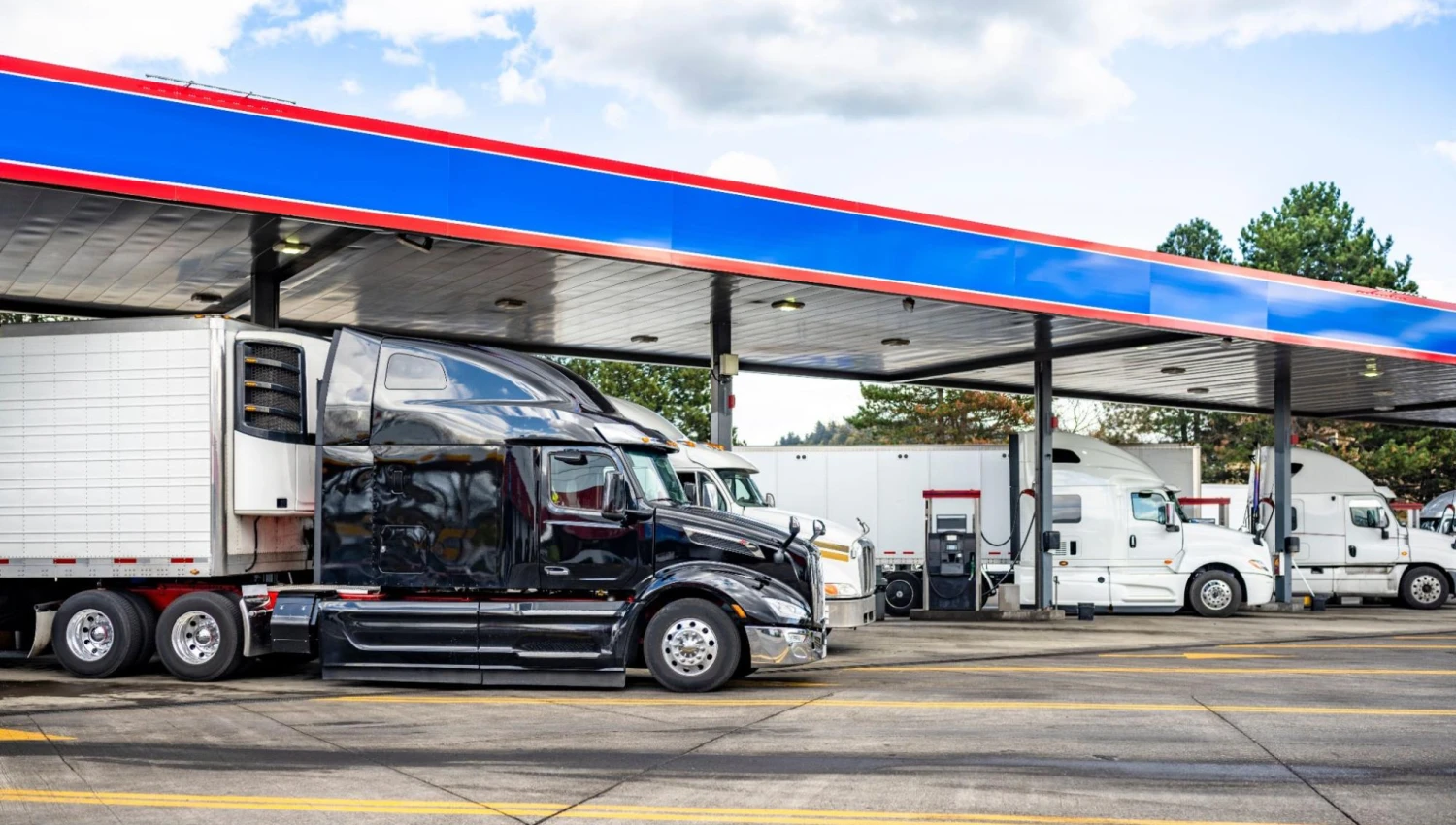 Industrial big rigs semi truck tractors with semi trailers standing in a row