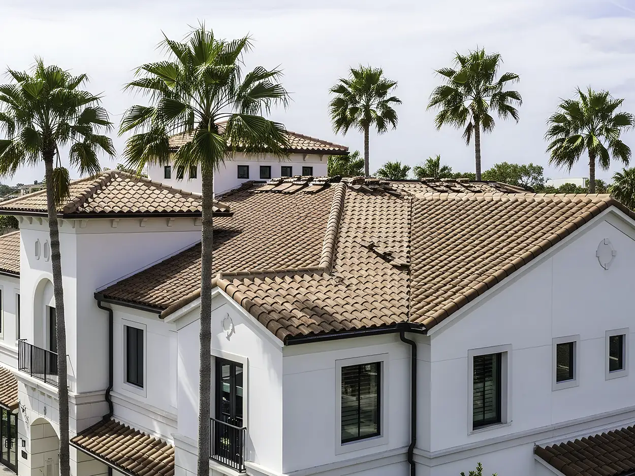 Completed commercial roofing project with Mediterranean tile installation on a multifamily building, highlighting precise and durable roof replacement work.