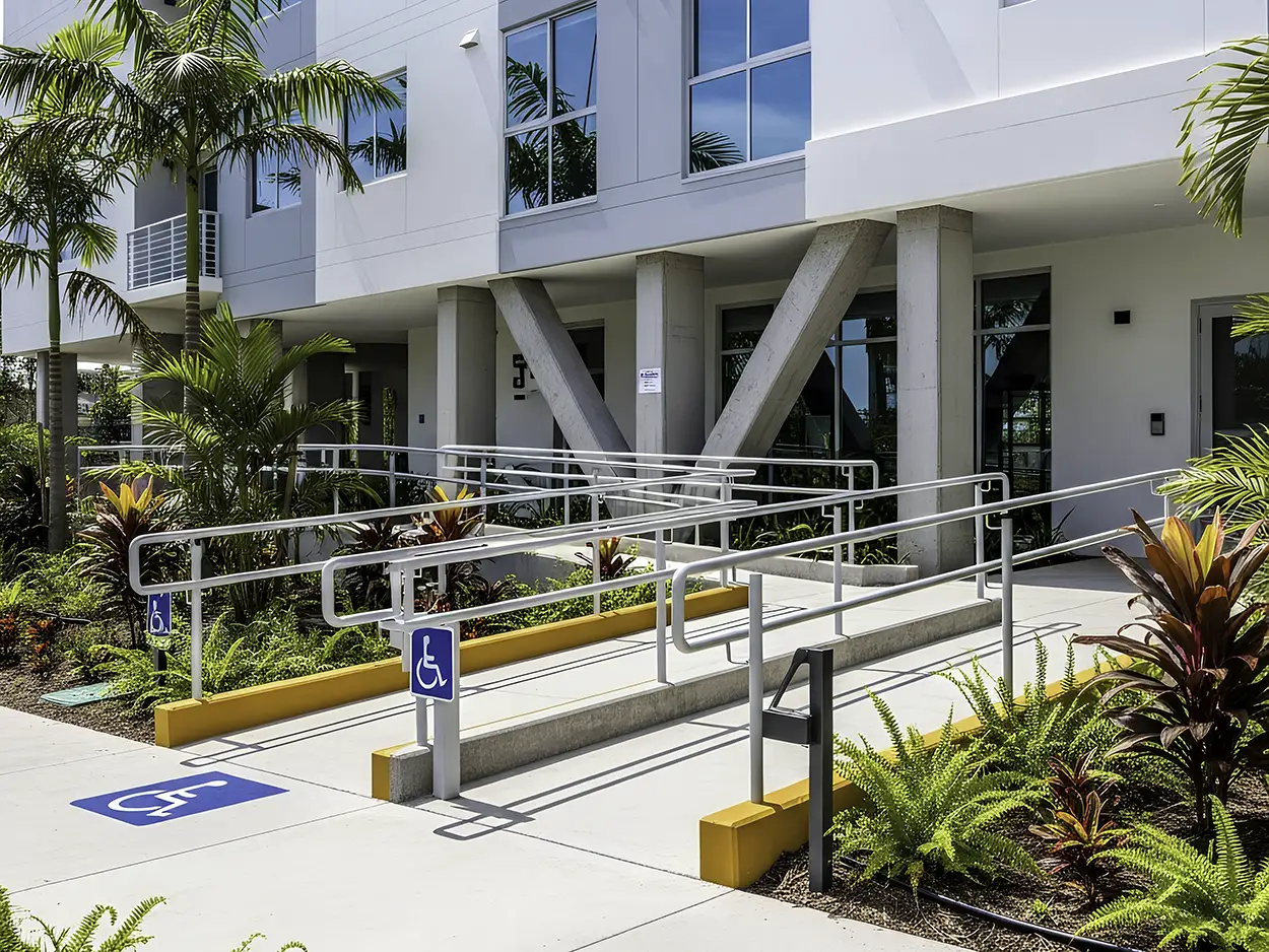 Commercial building with fully completed ADA-compliant access ramp and exterior improvements, meeting safety and accessibility compliance standards.