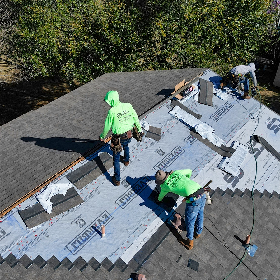 Roofers working on a full roof replacement in pflugerville texas