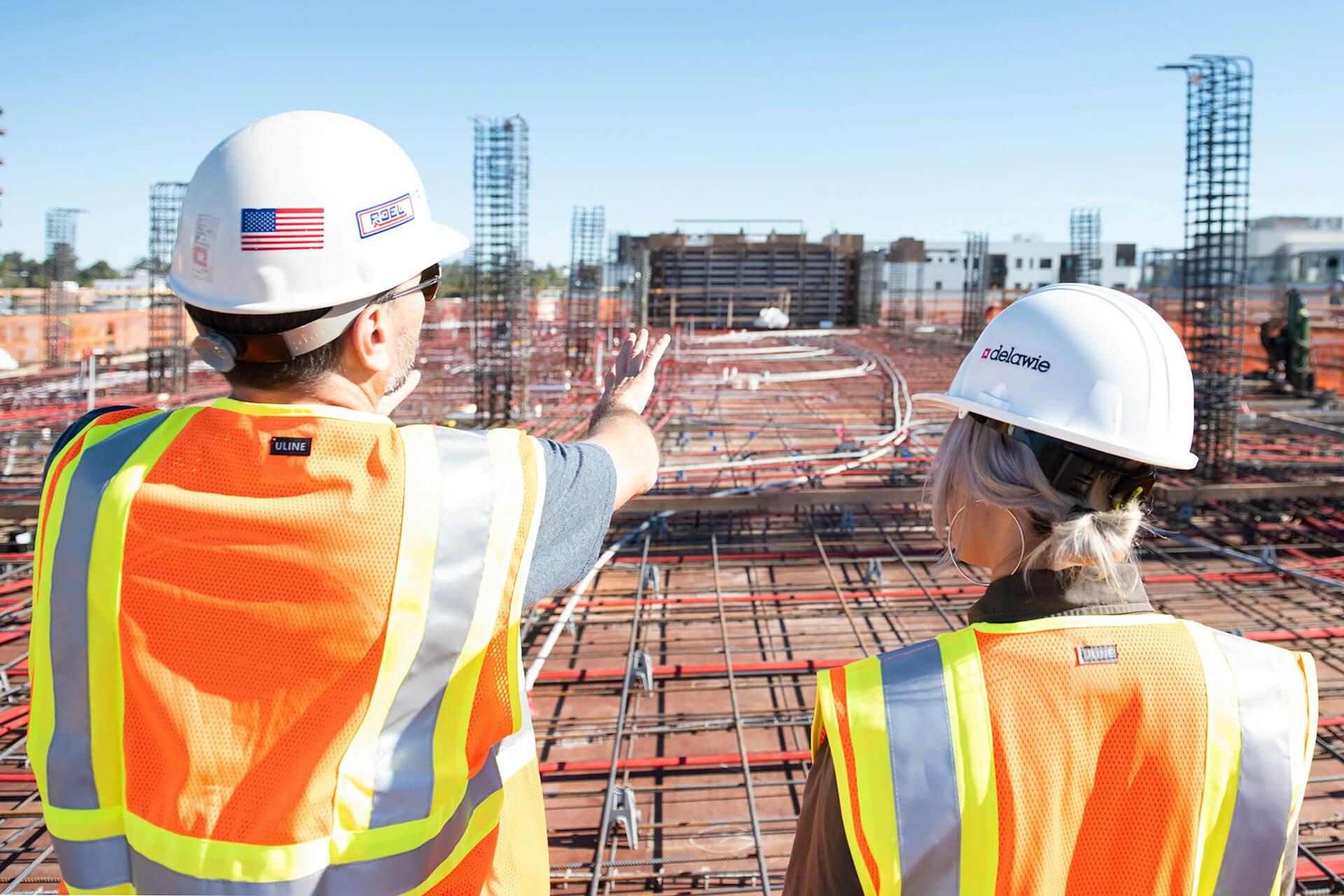 man in white hard hat standing on brown wooden dock