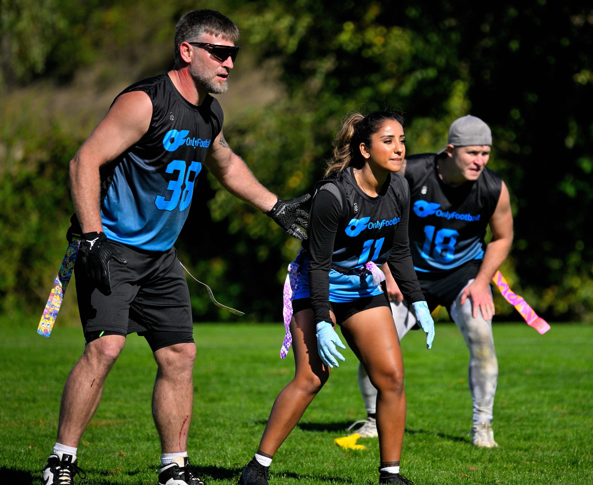 three flag football players ready to play