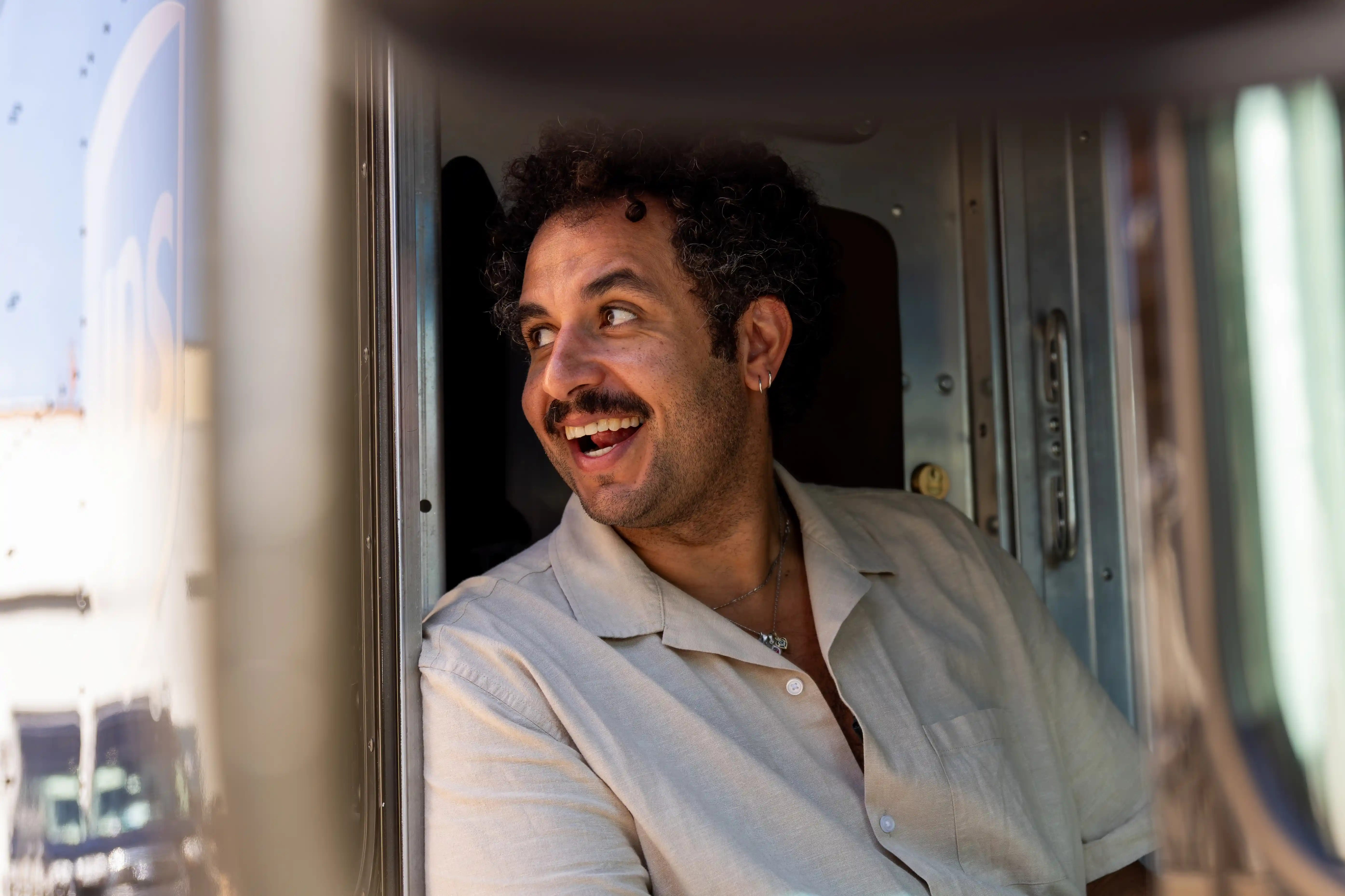 Kareem Rahma standing with a UPS driver in brown uniform during Business Trips shoot — So & So Productions photo