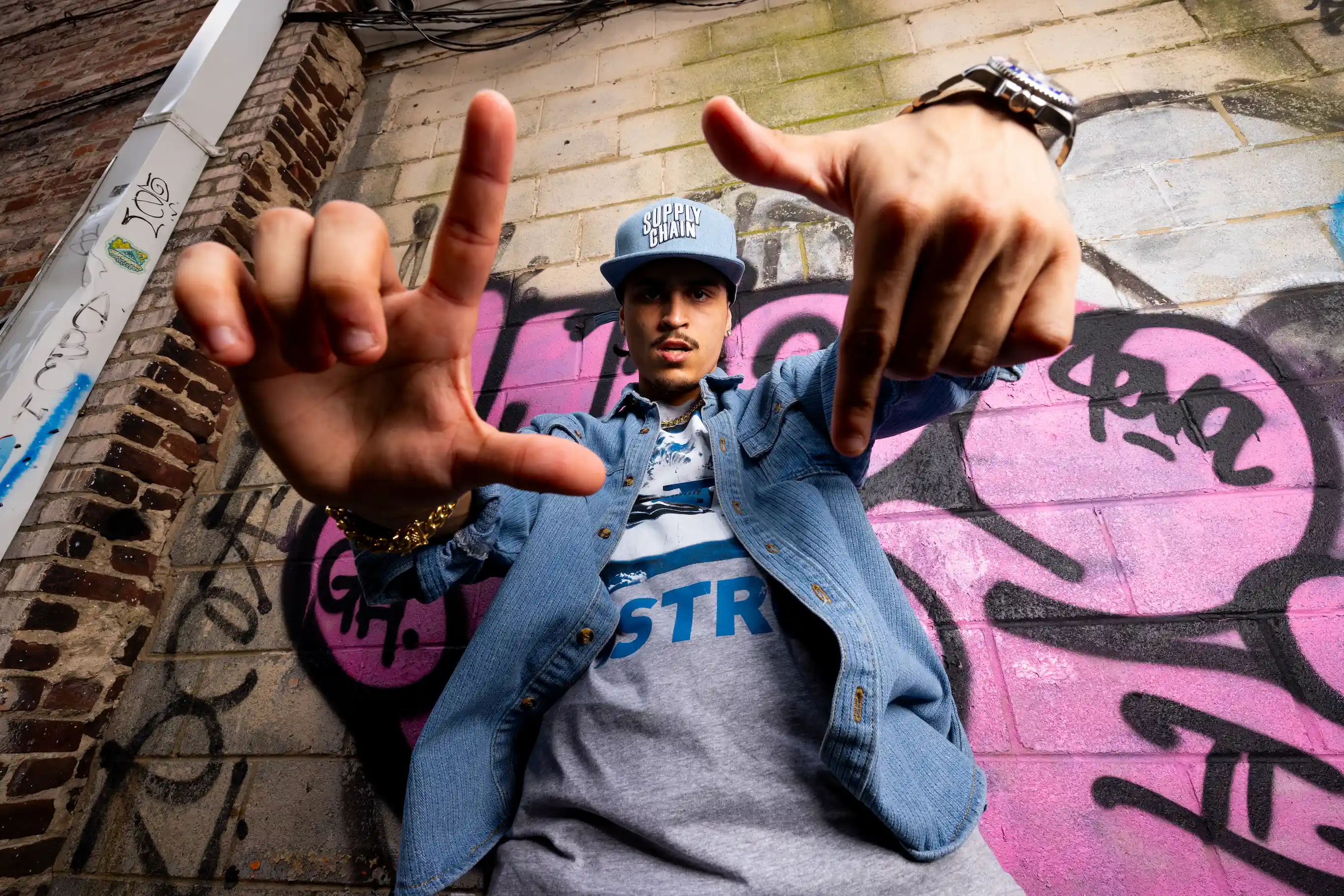 Model wearing Supply Chain Distro graphic tee in urban streetwear shoot — So & So Productions fashion photography