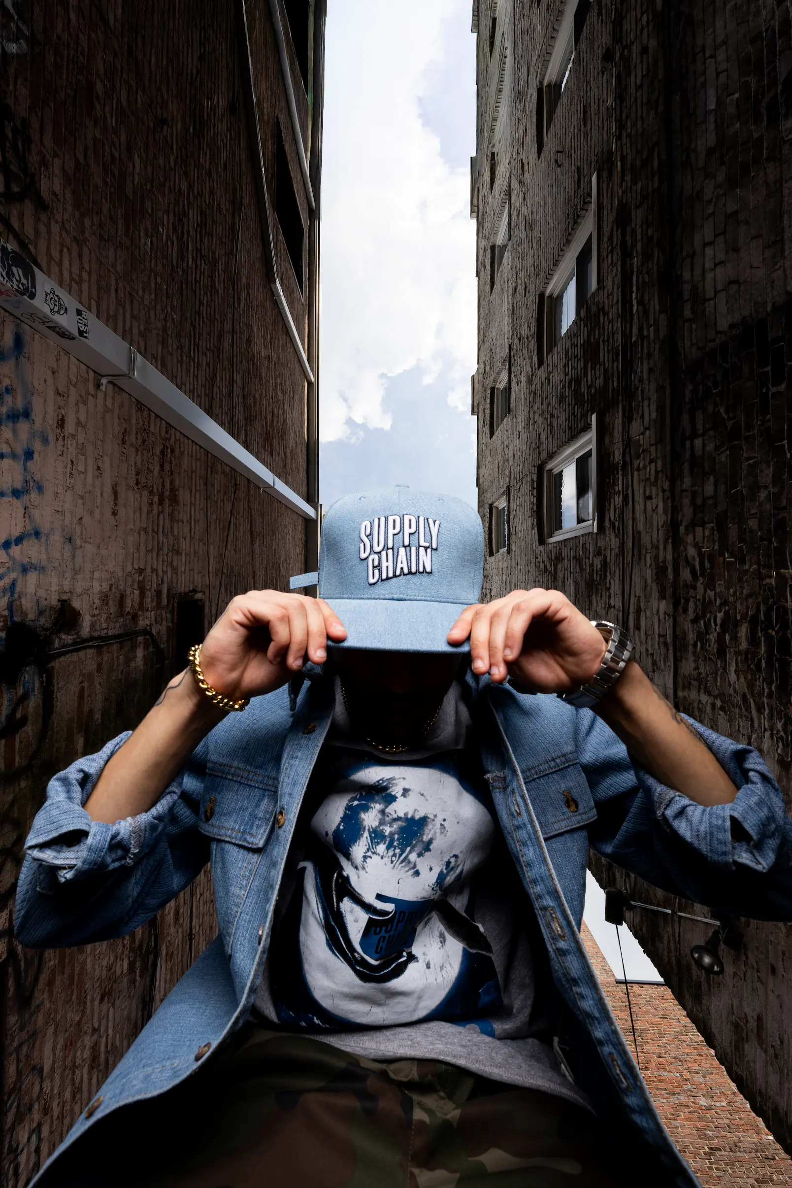 Model wearing Supply Chain Distro graphic tee in urban streetwear shoot — So & So Productions fashion photography