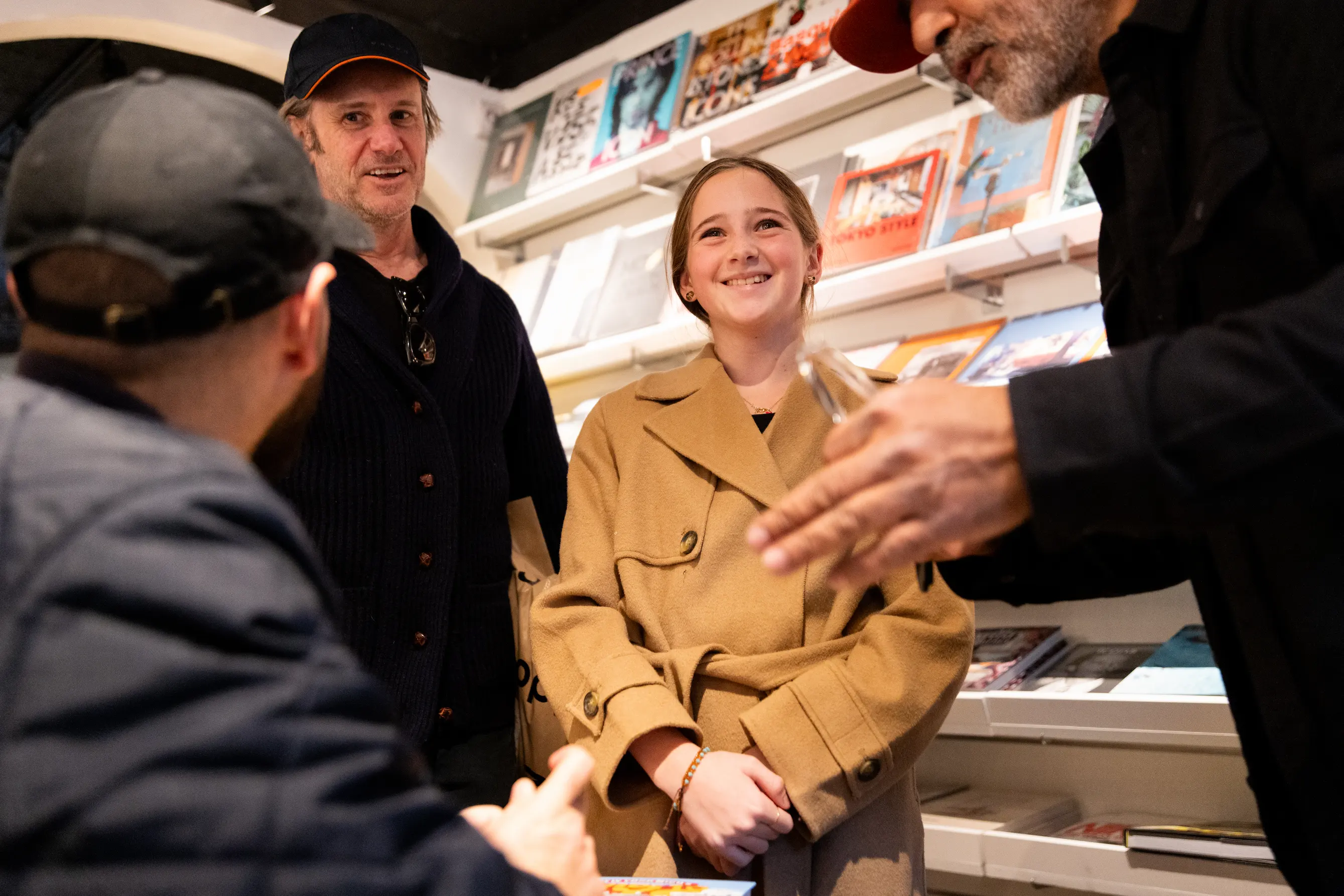 Candid of New York Nico chatting with guest while holding his book — So & So Productions behind-the-scenes photo.