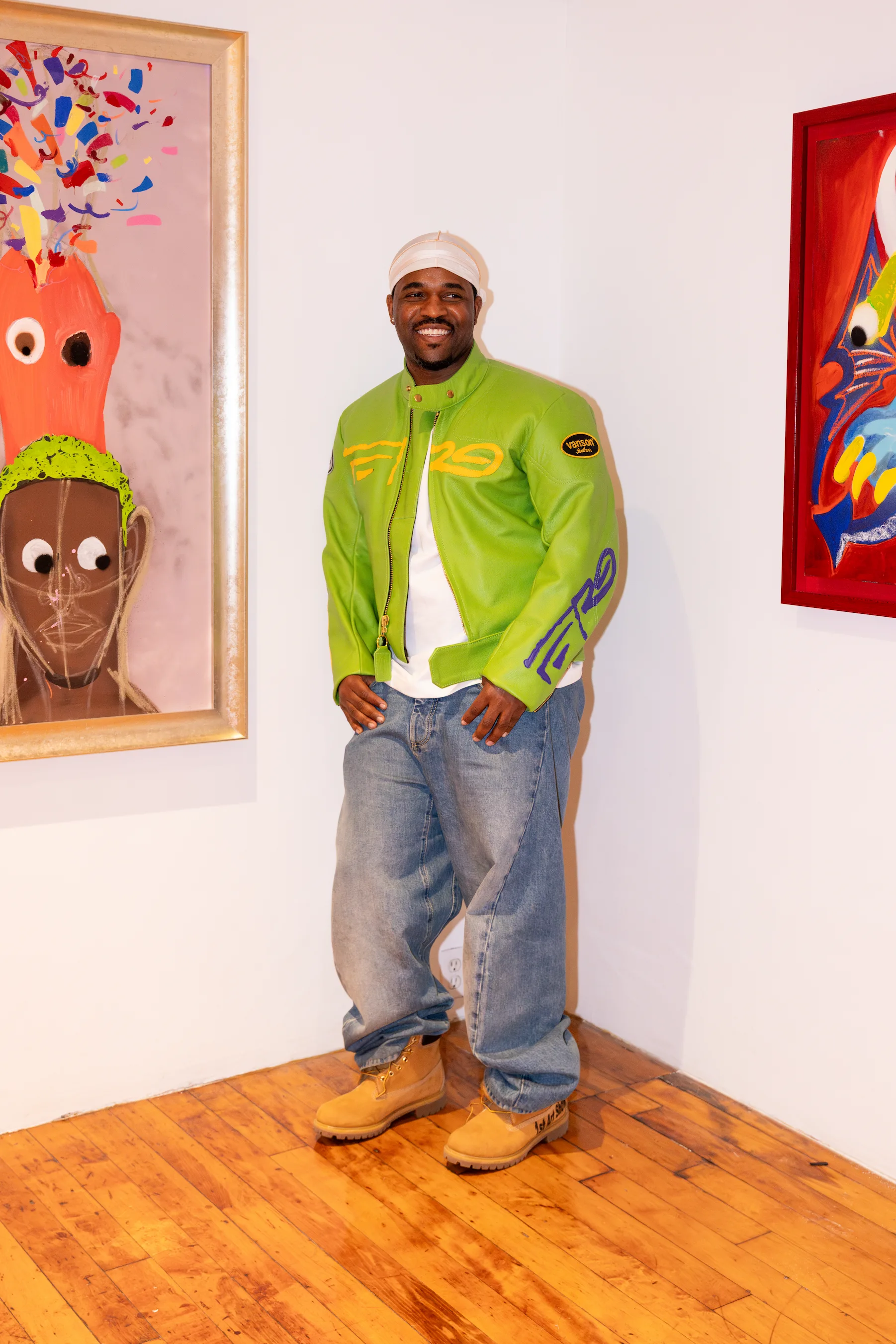 A$AP Ferg standing beside his painting at the CHOSEN Exhibition in Soho — photo by So & So Productions