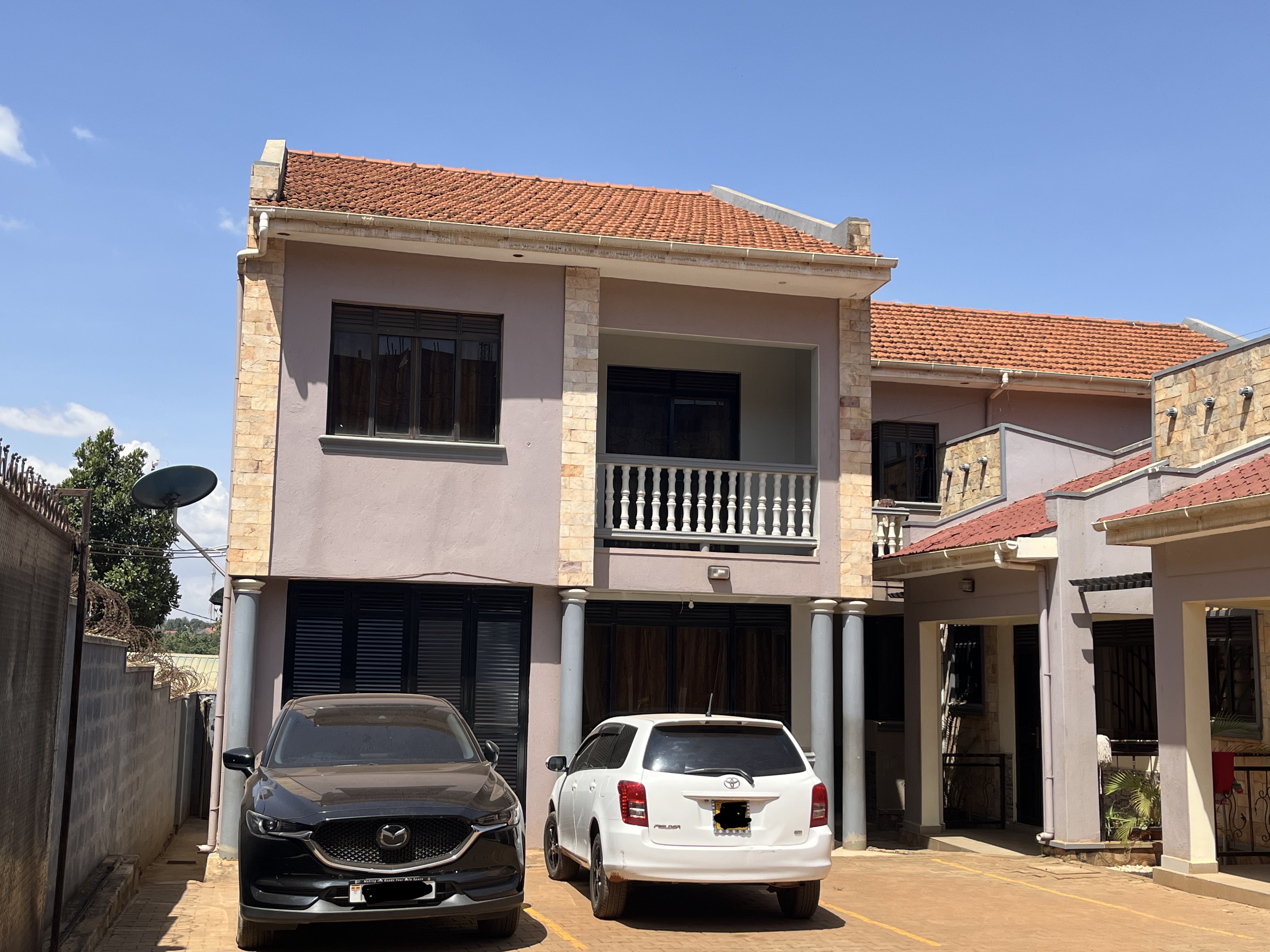 Income property exterior with secure fencing and gated access in Wakiso Uganda