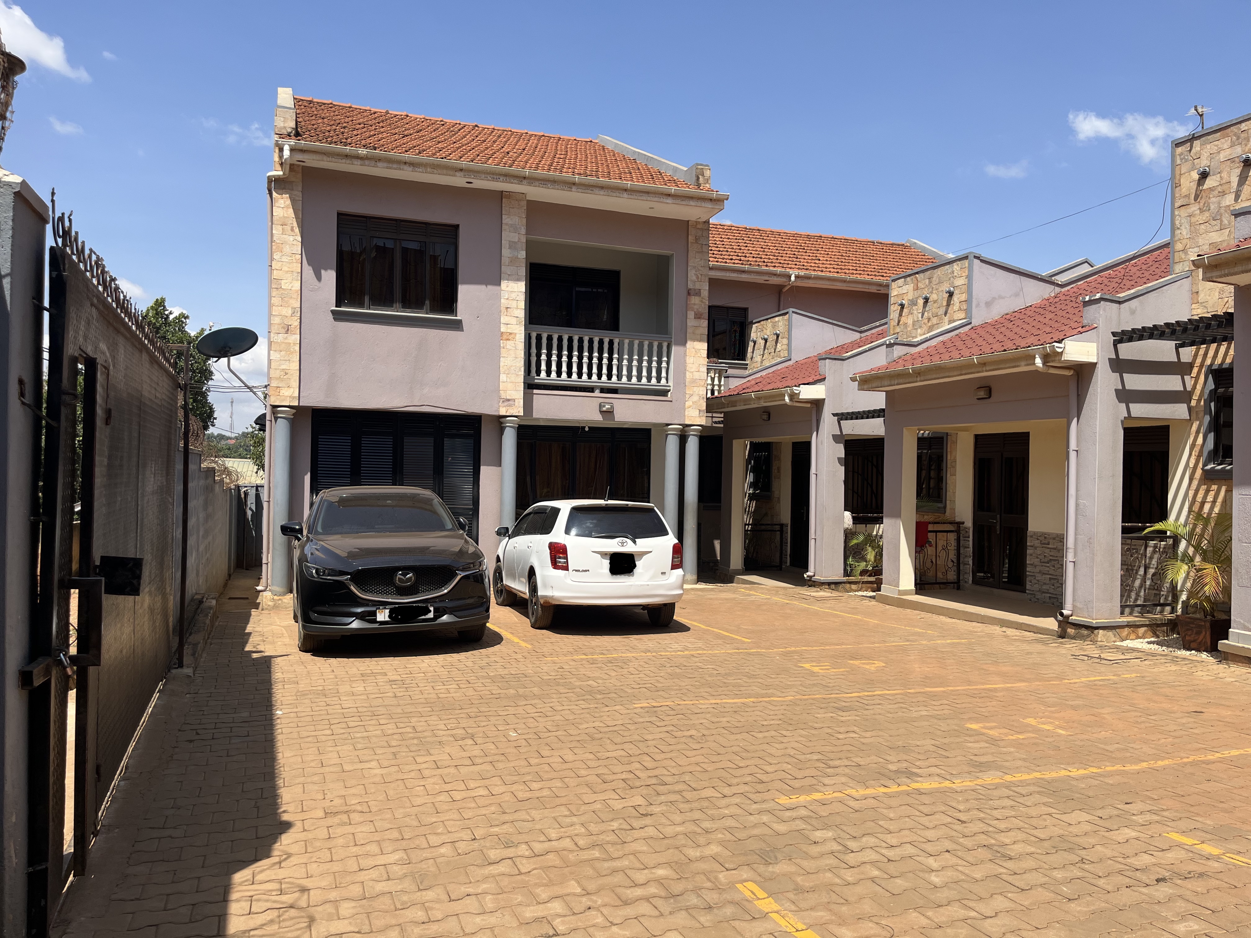 Exterior view of rental apartments with tarmacked road access in Wakiso District